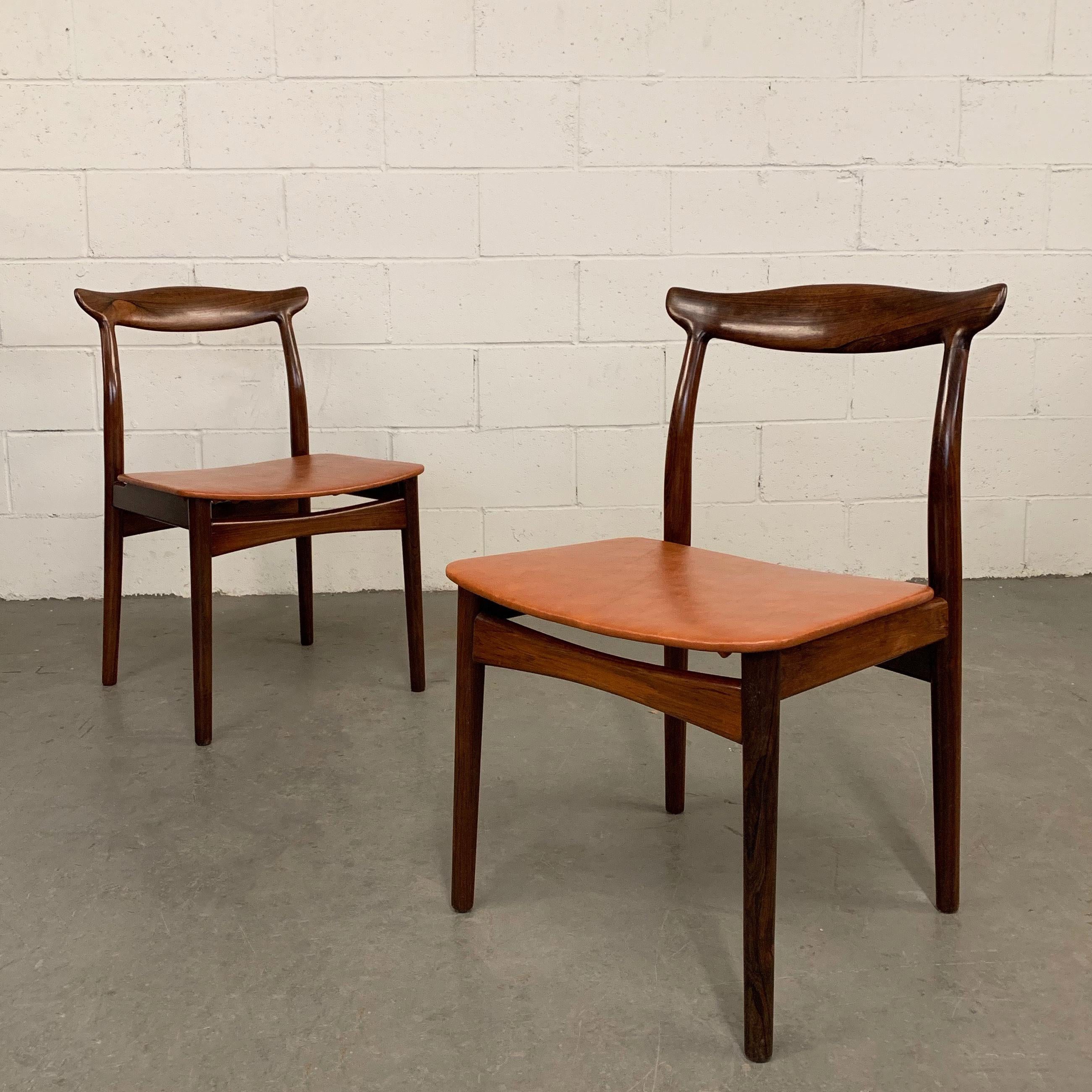 Pair of elegant, Danish modern, model 112 chairs by Erik Wørts for Vamo Møbelfabrik feature rosewood frames with cow Horn backs and floating leather seats.