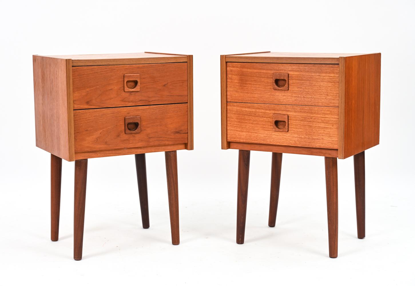 A fabulous pair of Danish mid-century nightstands or bedside petite chests in teak veneer designed by Erik Brouer, c. 1960's. Imbued with Scandinavian modern aesthetic, these end tables feature sculptural recessed drawer pulls and well-proportioned