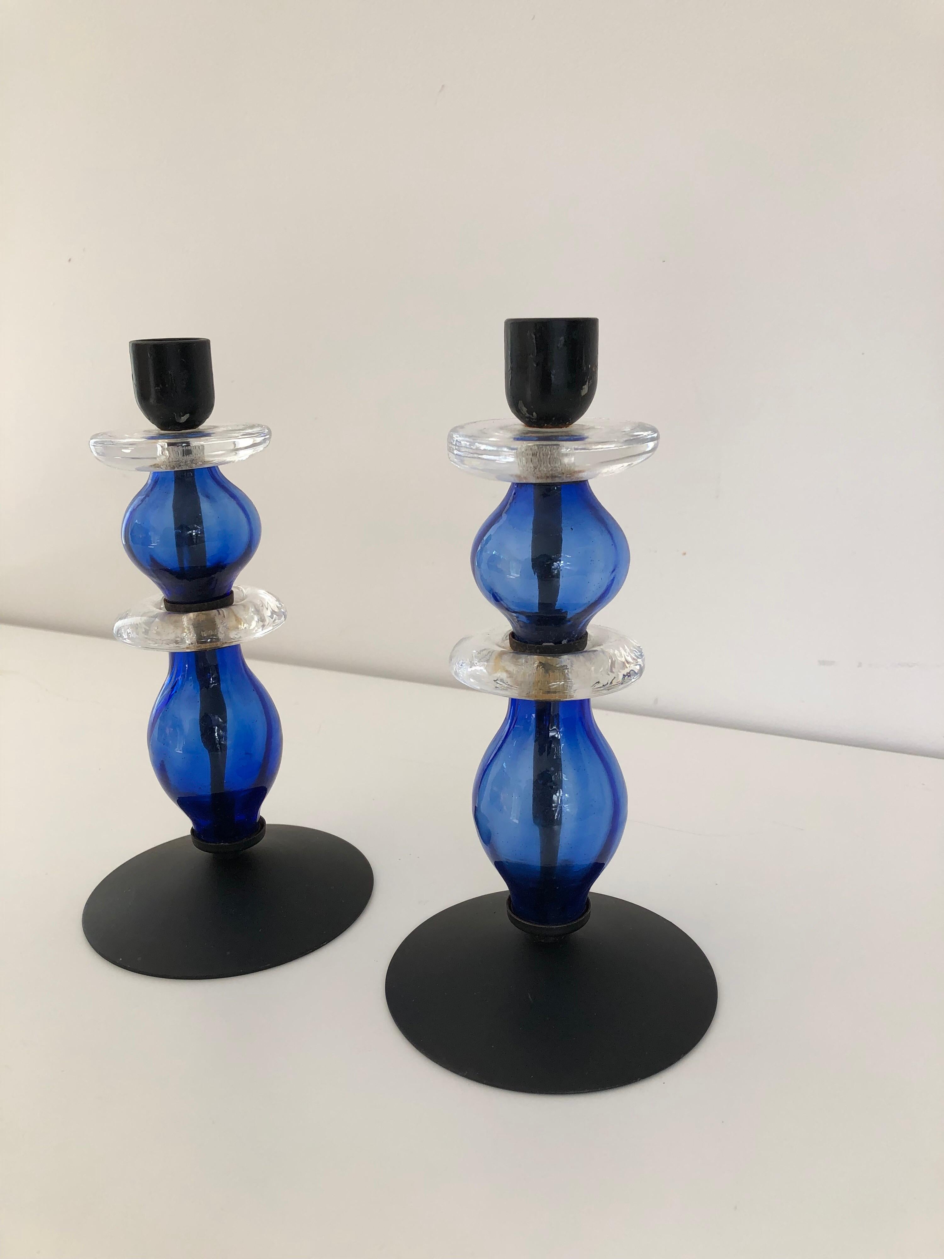 A rare pair of double tier glass and black painted metal candlesticks by Erik Hoglund for Boda. Consisting of two tiers of blue and clear glass.