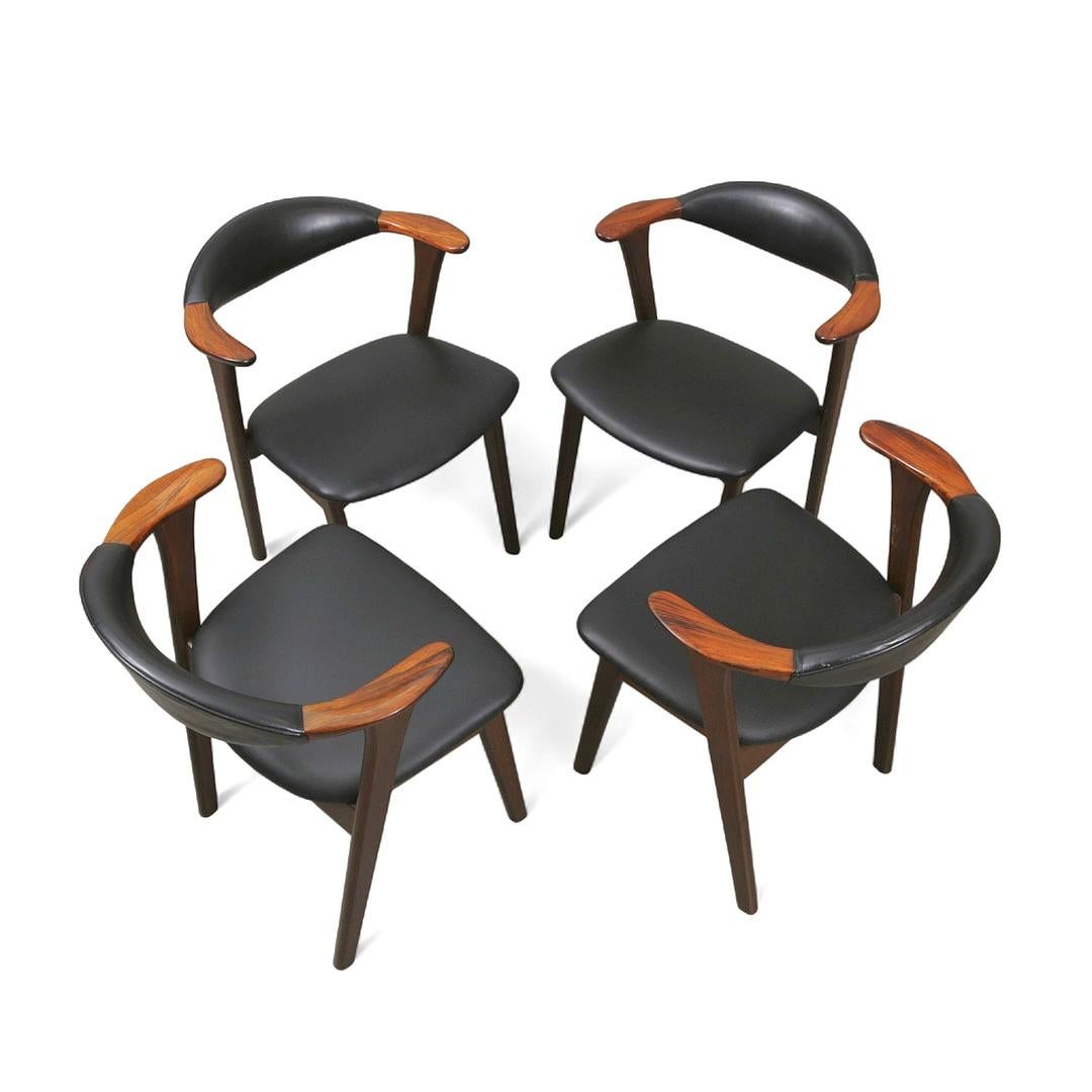 Armrests in rosewood, stained beech, and black leather for these Erik Kirkegaard chairs. An elegant design with a beautiful junction of the backrests and armrests. The leather on the backrests is original, while the seats have been reupholstered in