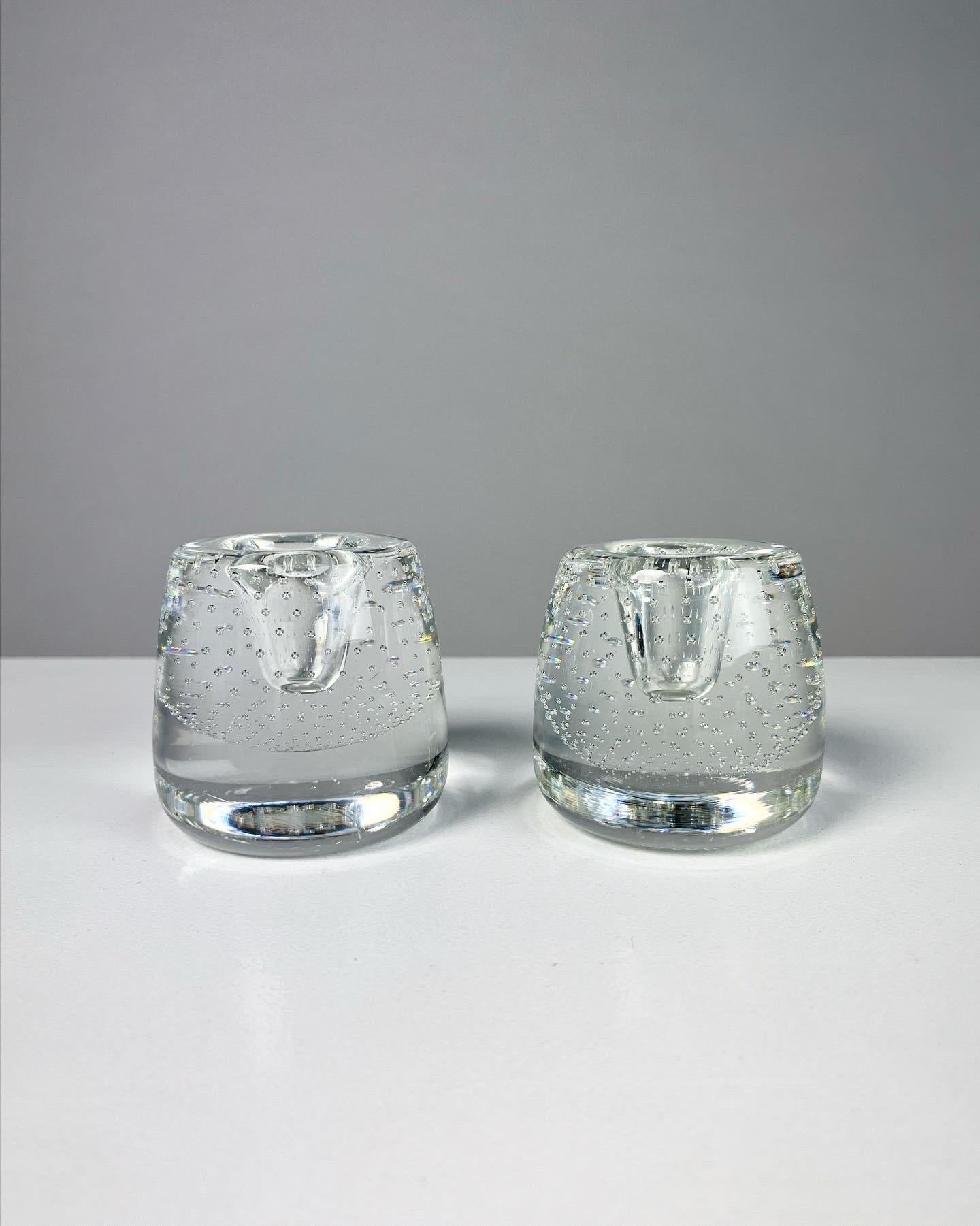 Pair of rare glass candle sticks by Ernest Gordon for Åfors glassworks in Sweden, 1960s.
Hand-formed with a controlled bubble pattern, signed on bottom.

Diameter: 7 cm
Height: 7 cm
For candles with a diameter of 2 cm

