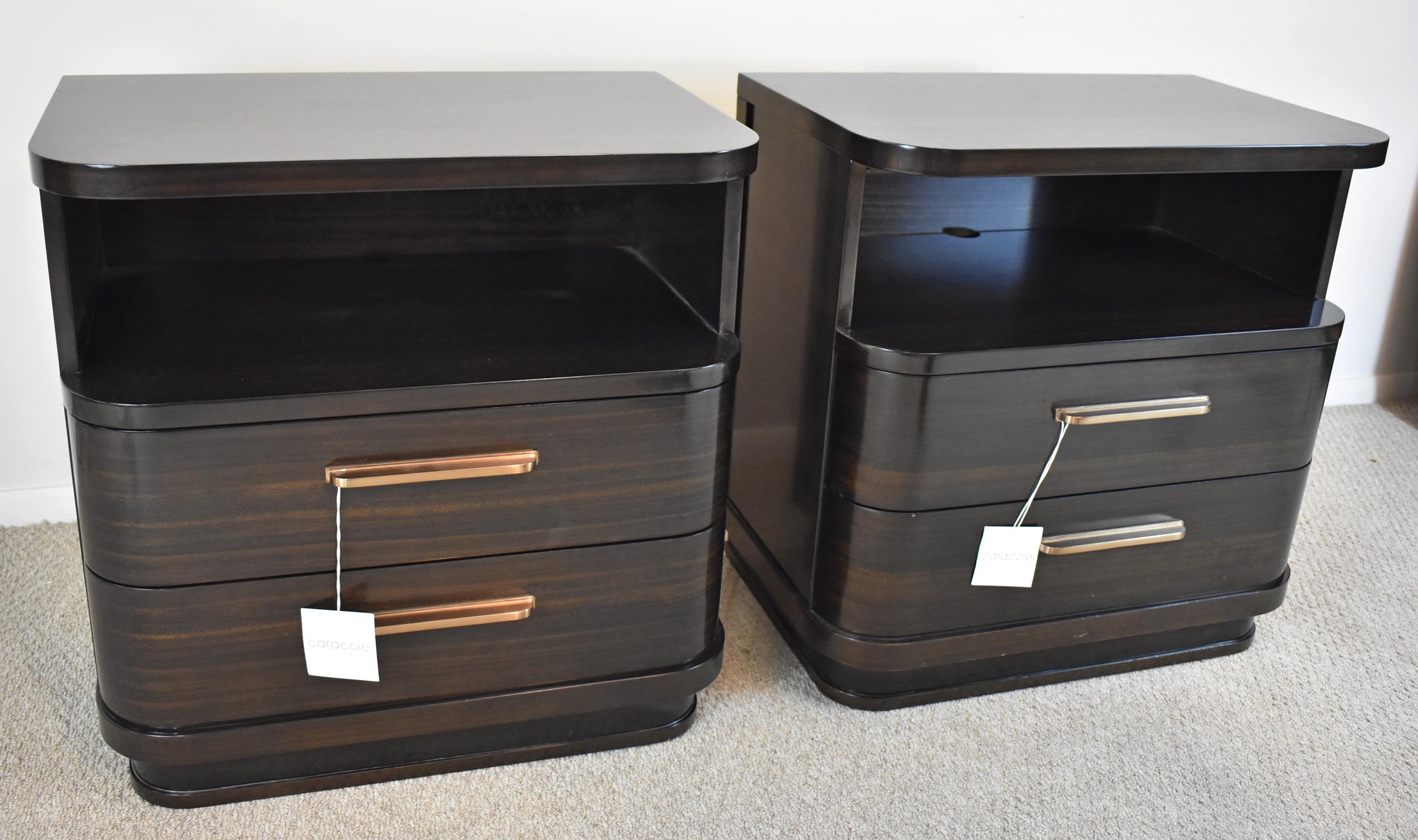 Pair of Espresso Finish Caracole Streamline Nightstands. Circa 1940's. Modern dark stained Mahogany stands with sporting rounded corners a solid recessed plinth base and retro-era Coppertone hardware handles. Open compartment with wire access