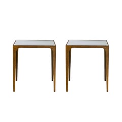 Coppia di tavolini “Esquisse” con finitura dorata e piano in pelle di capra di Design Frères