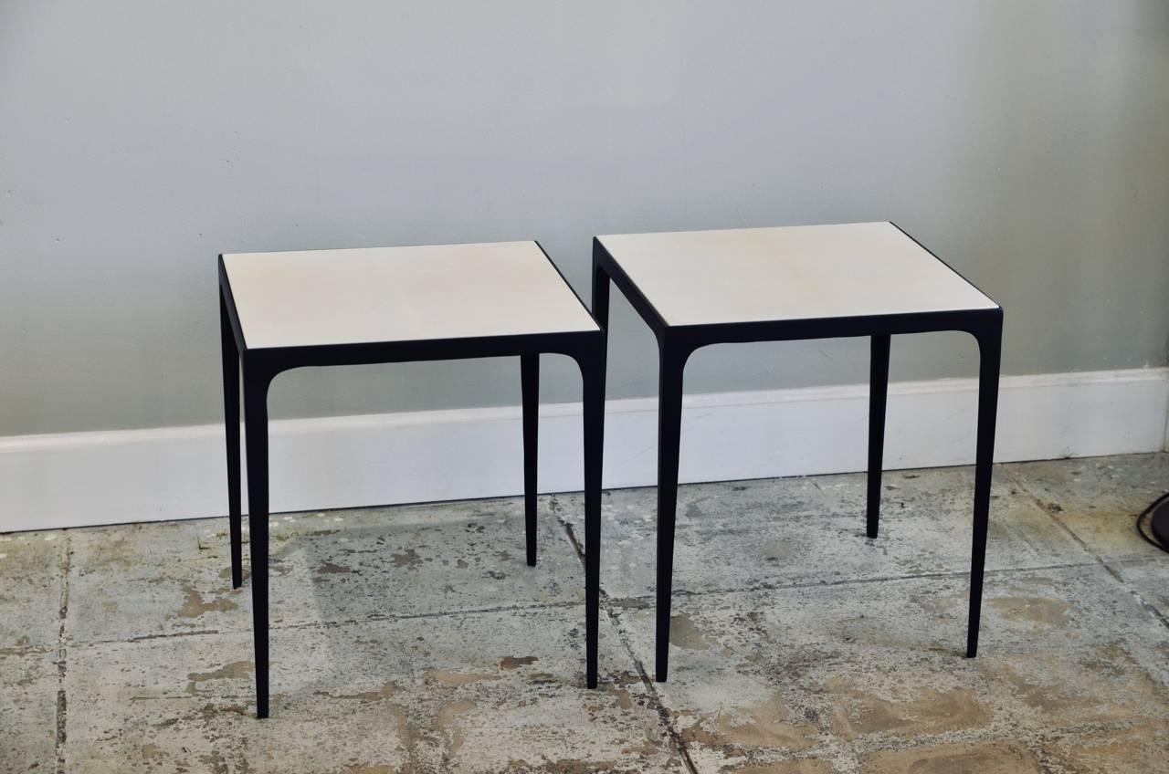 Pair of 'Esquisse' parchment and wrought iron side or end tables by Design Frères. Hard to find real parchment tops fitted onto a slender matte black steel frames.
