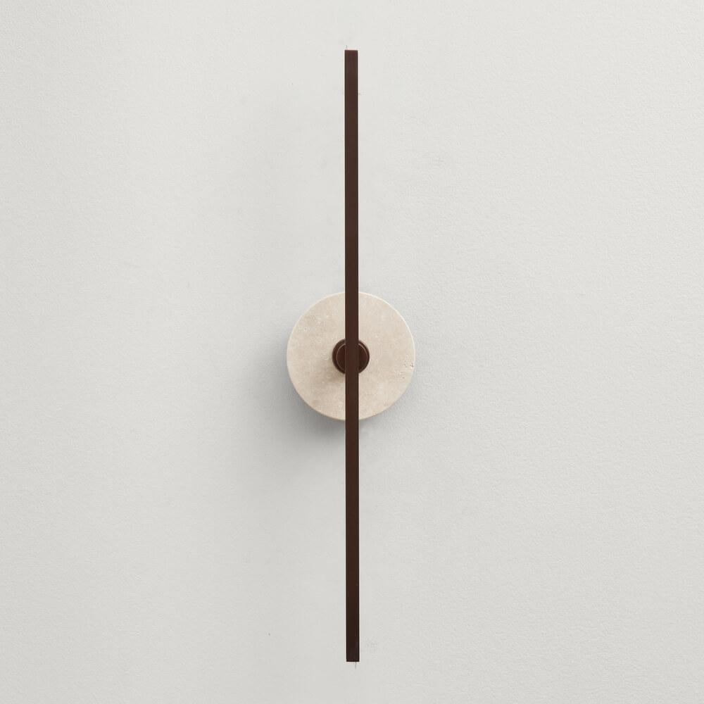 The Stick wall sconce is a contemporary lighting fixture that features a minimalist design with thin brass profiles and advanced LED technology. It emits a warm and diffused light that adds a cozy and inviting atmosphere to any room.

The brown
