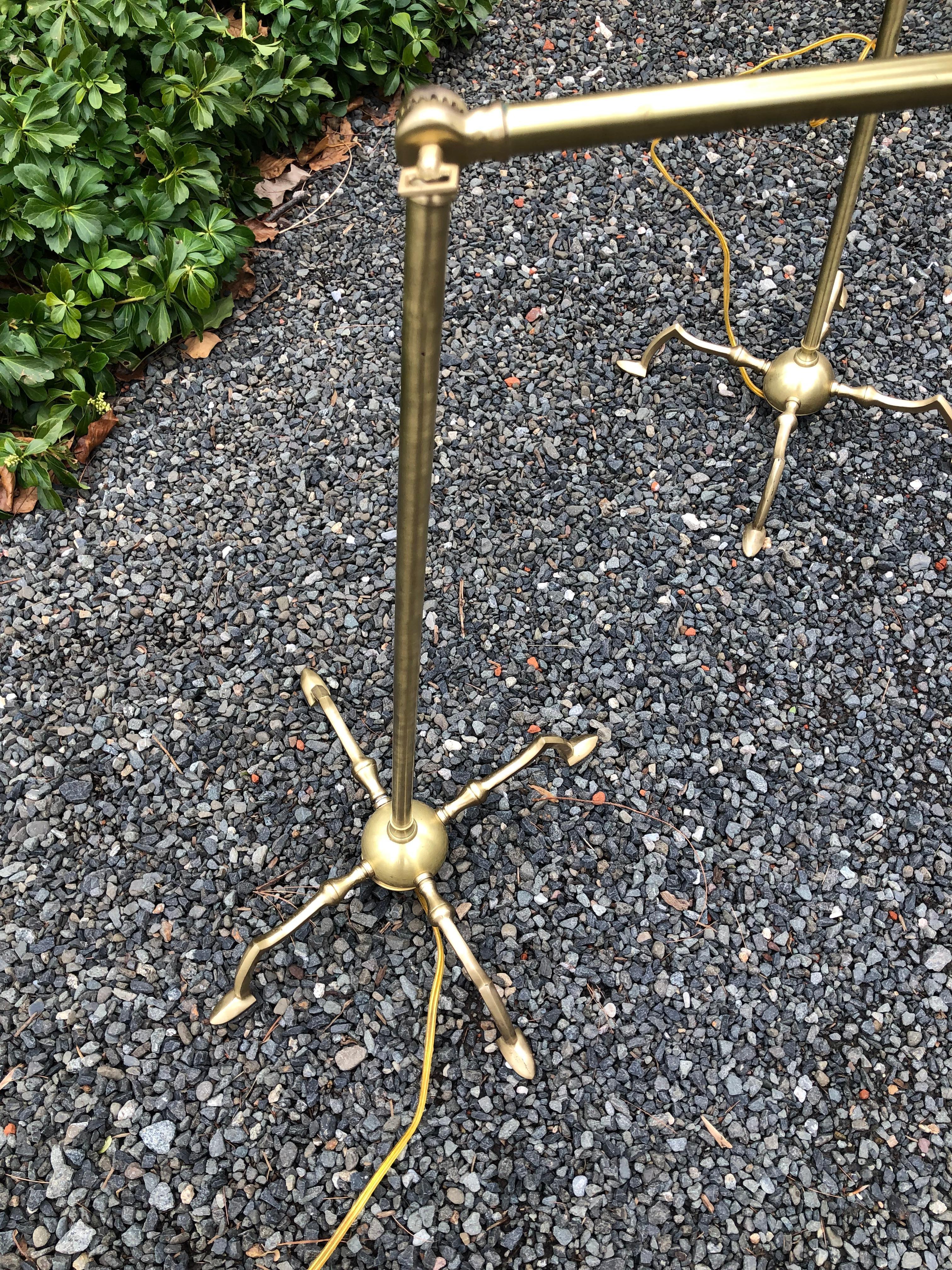 Handsome and practical, a pair of “Essex” tripod reading lamps in brushed brass finish. The lamps can be adjusted both in height and angle for reading. Switches are operated by a floor button on cord. Unmarked.
