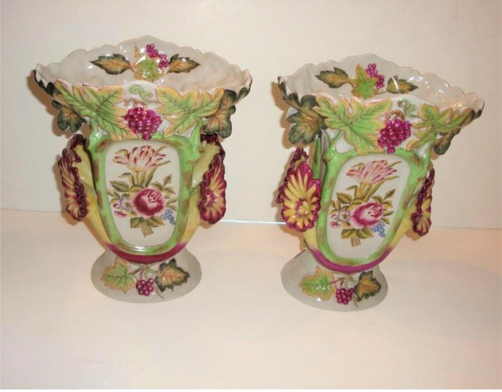 The Following Item we are offering is a Spectacular Pair of Estate Handpainted European Grape Leaf Floral Centerpiece Urns / Vases. Very Finely and Exquisitely Detailed. Excellent Condition and Signed on the bottom. Taken out of an Important New