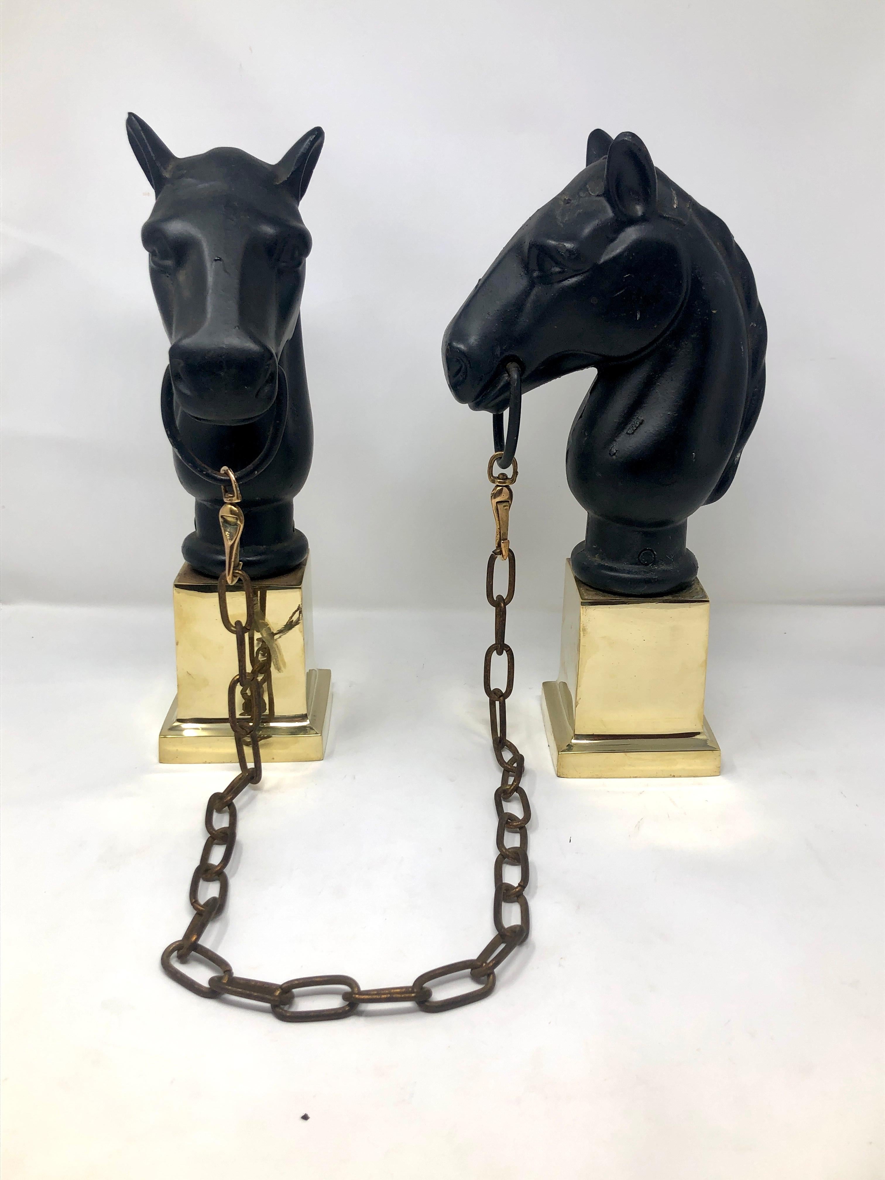 Pair of estate wrought iron horse head chenets with brass bases.
These sit onto the front of andirons, but we can custom fabricate and add wrought iron billet bars to the backs to make them andirons.  (It would take approximately 2 weeks and would