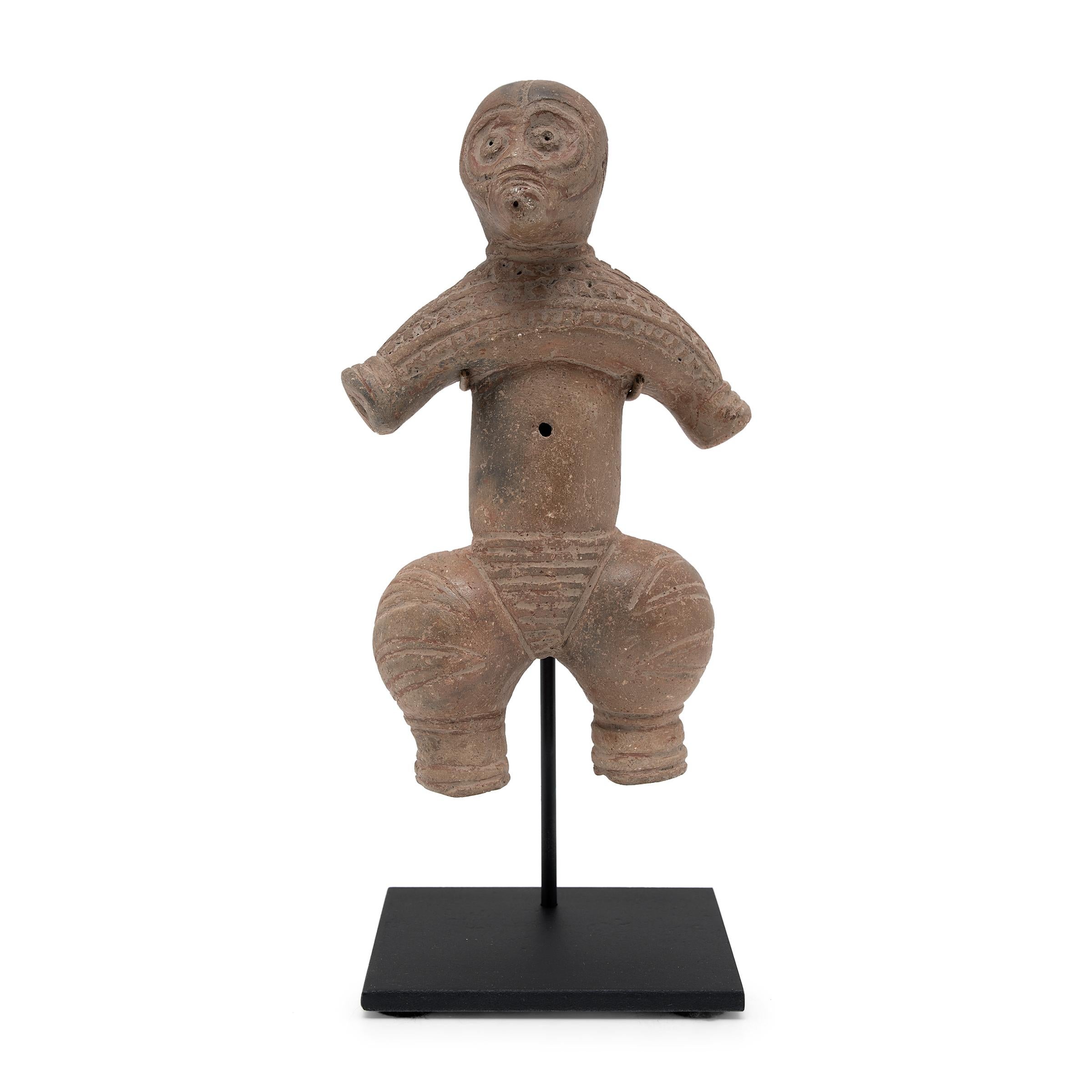 This intricately styled pair of terracotta figurines is sculpted in the style of Japanese Dogū sculptures of the Jōmon period (10th-4th century B.C.). Reminiscent of Pre-Columbian redware figures, Dogū ceramics are known for their primitive abstract