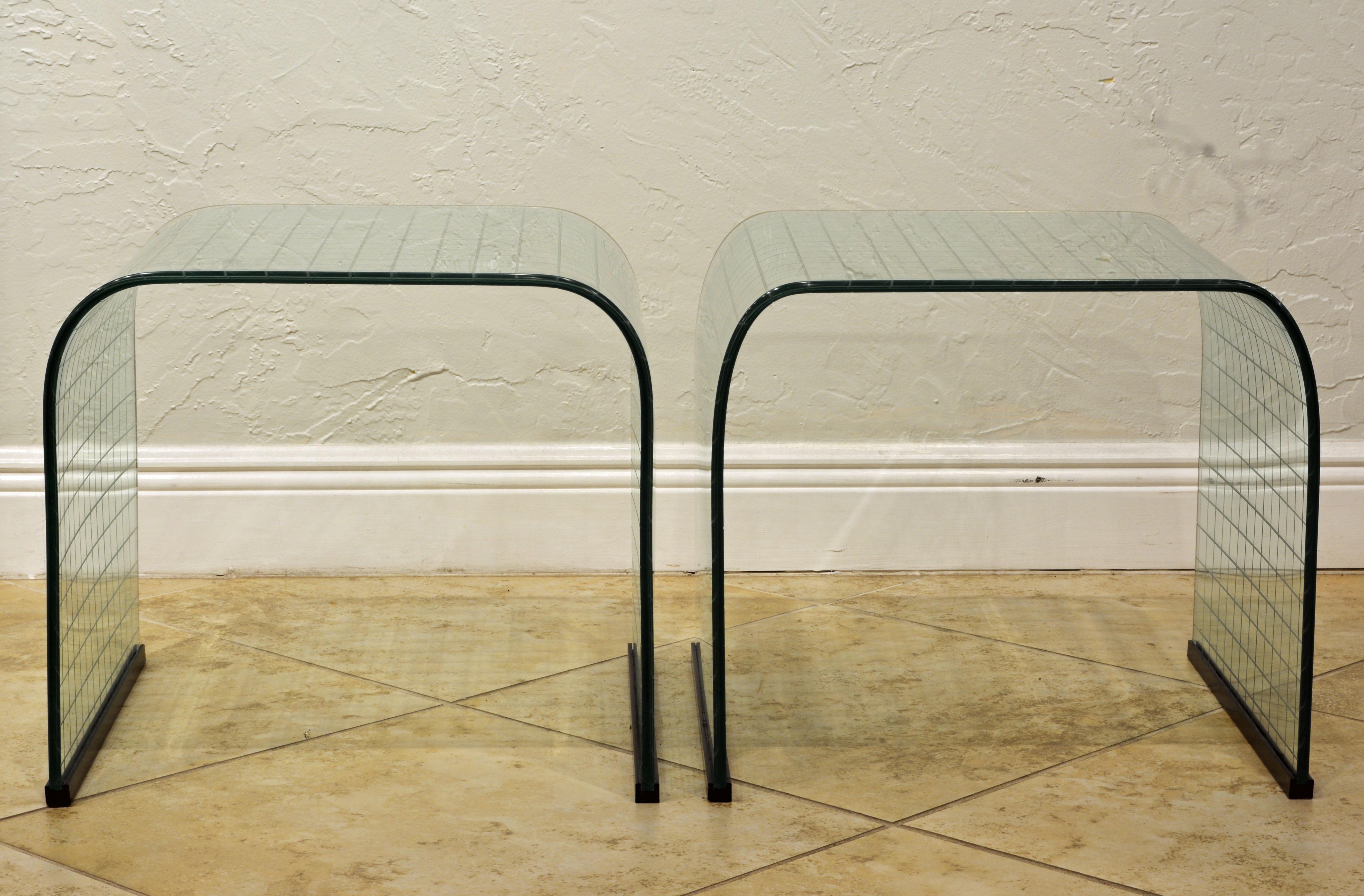 Pair of elegant glass side table designed by Italian designer and architect, Angelo Cortesi for Fiam of Italy in the 1970s. Sharp Mid-Century Modern design made from thick tempered and curved glass decorated with a square grid pattern and capped at