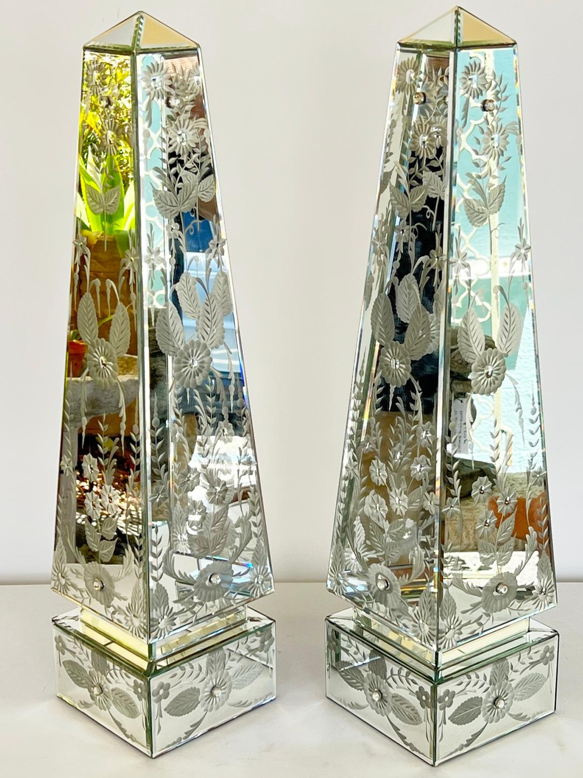 Pair of obelisks, clad in mirrorplate in the Venetian style. Each side is etched with scrolling florals. 

Stock ID: D1699.