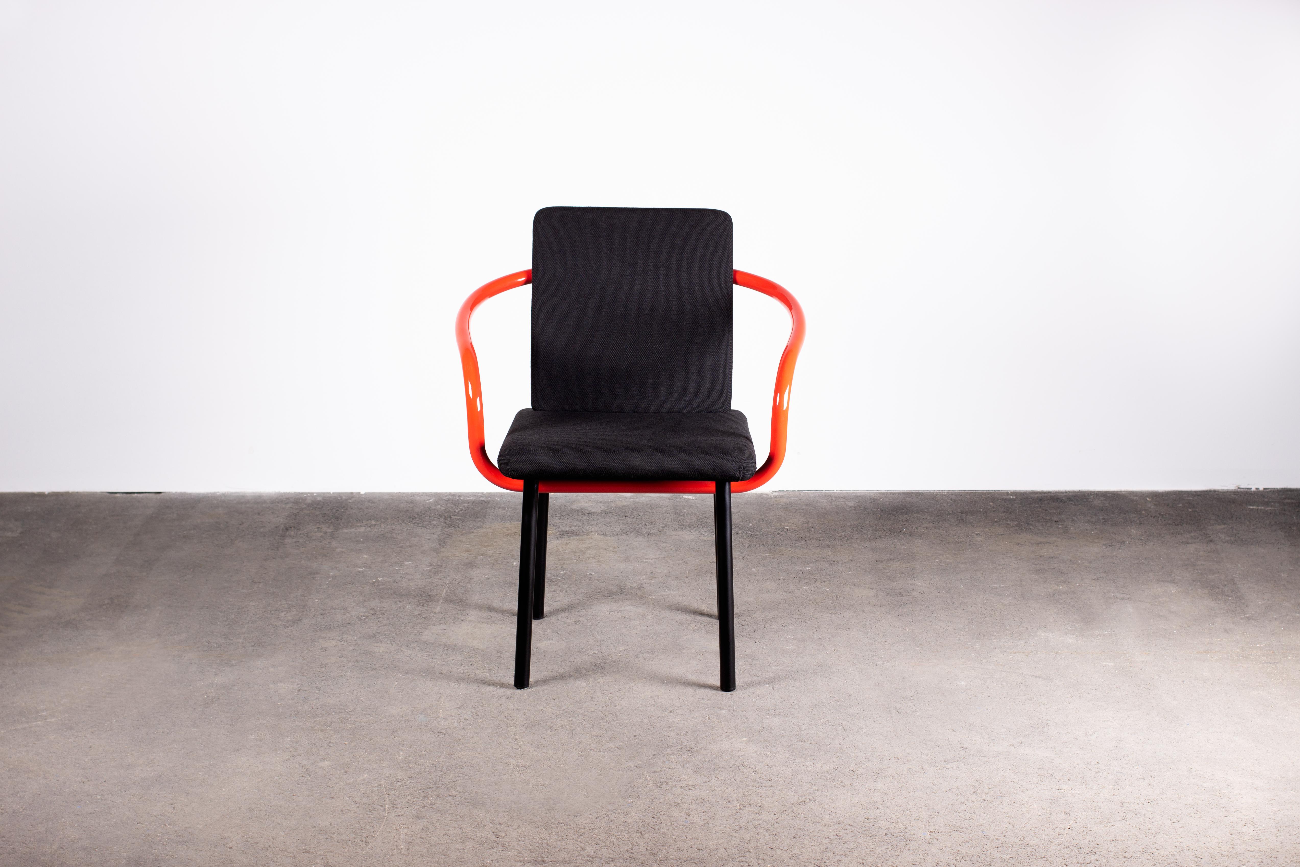 A 1986 design by Ettore Sottsass for Knoll, the Mandarin chair consists of a flat rectangular seat cushion and flat rectangular seat back. Both with rounded corners and upholstered in black fabric. This angular core is wrapped in an unbroken cycle