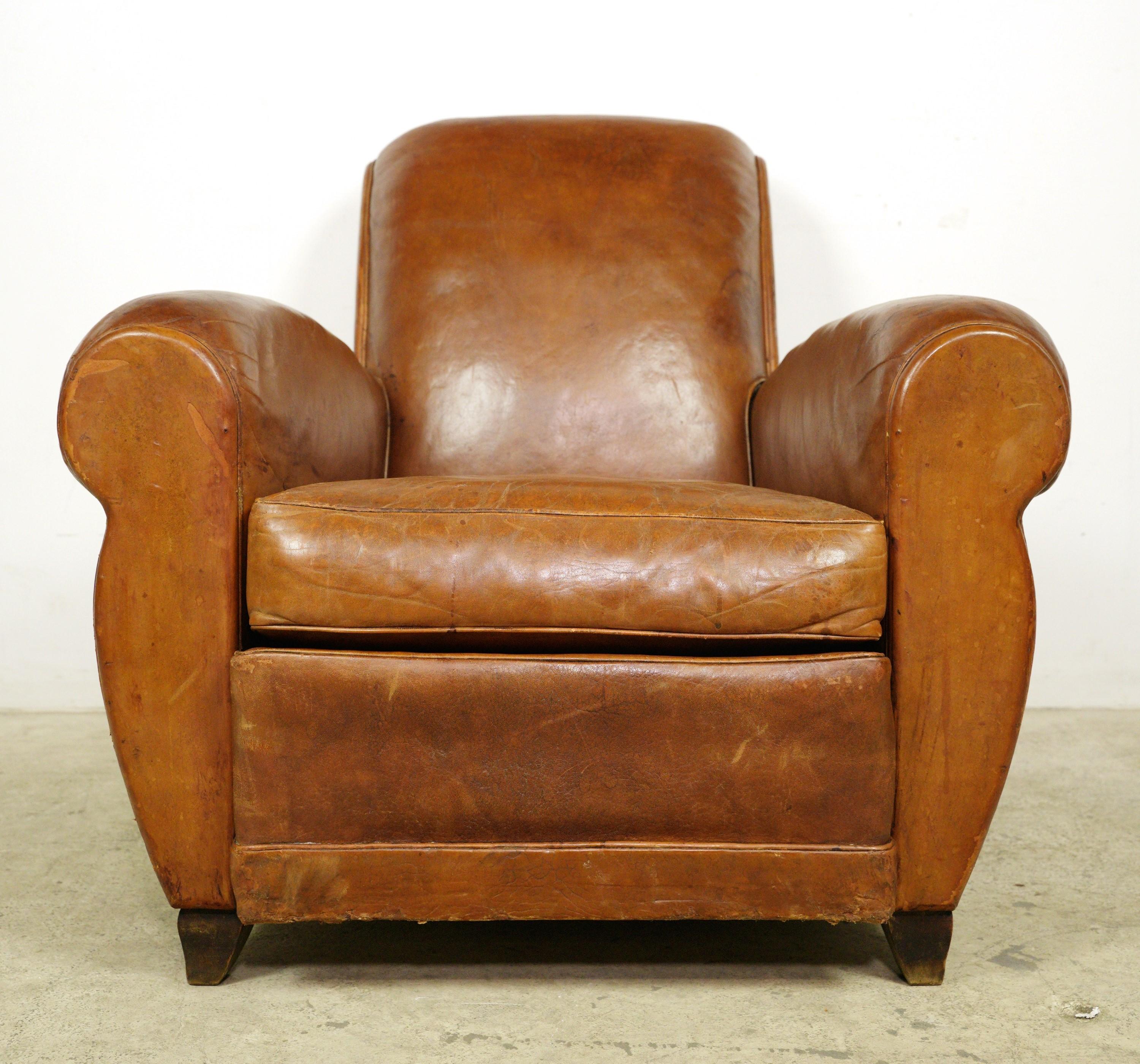 Recently imported from Europe, this pair of vintage brown leather club chairs make a great statement of informal luxury and chic. With a reclined back and oversized arms, the seat is sturdy yet comfortable. The leather is sheepskin with a light