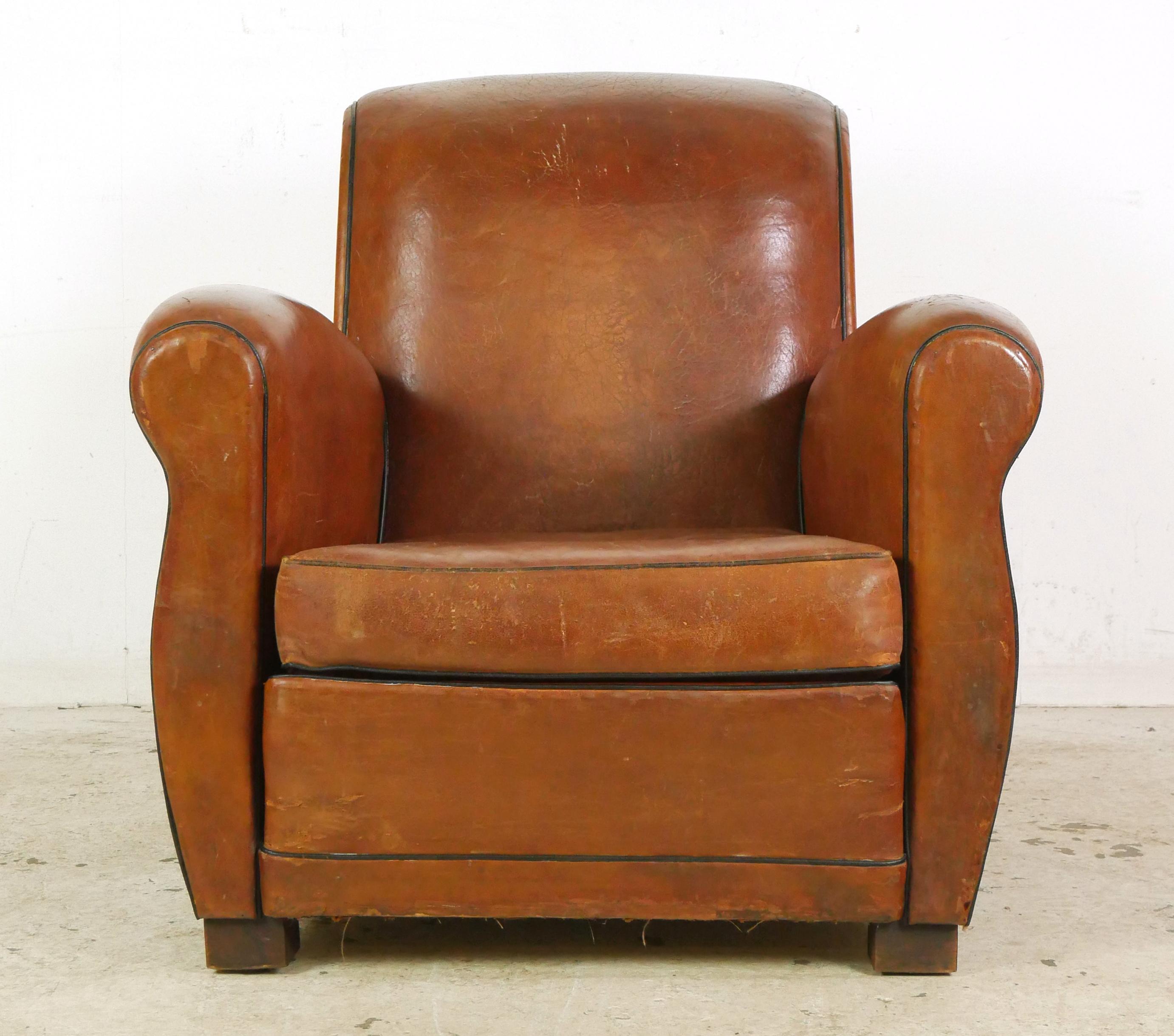 Pair of brown leather studded back club chairs made in France. Please refer to the pictures for a full view of the condition. Good condition with surface wear from prior use. Priced as a pair. Please note, this item is located in our Scranton, PA
