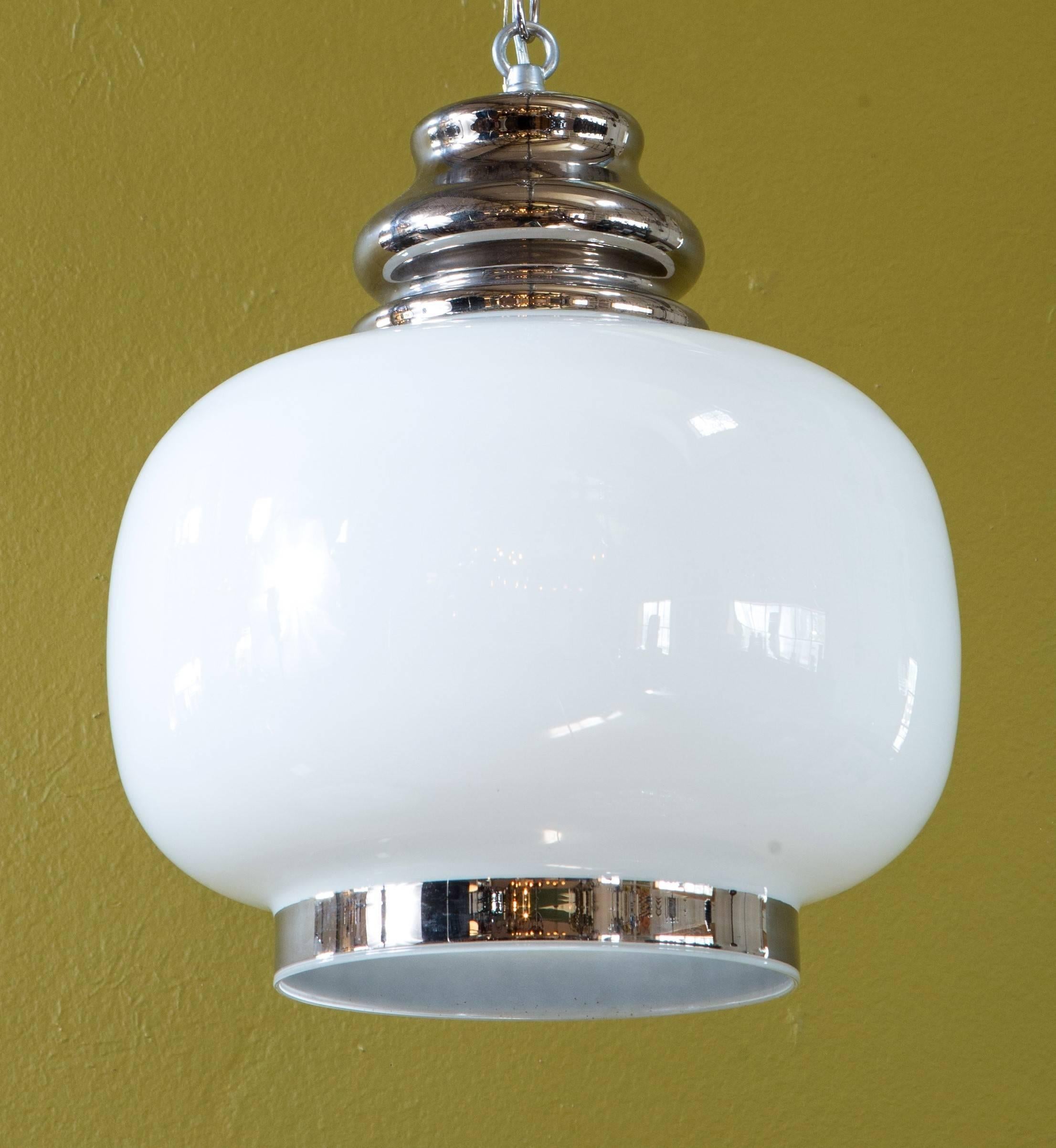 Pair of European hand-blown milk glass pendants with painted 'nickel' accents. Fascinating white glass pendant with hand painted 