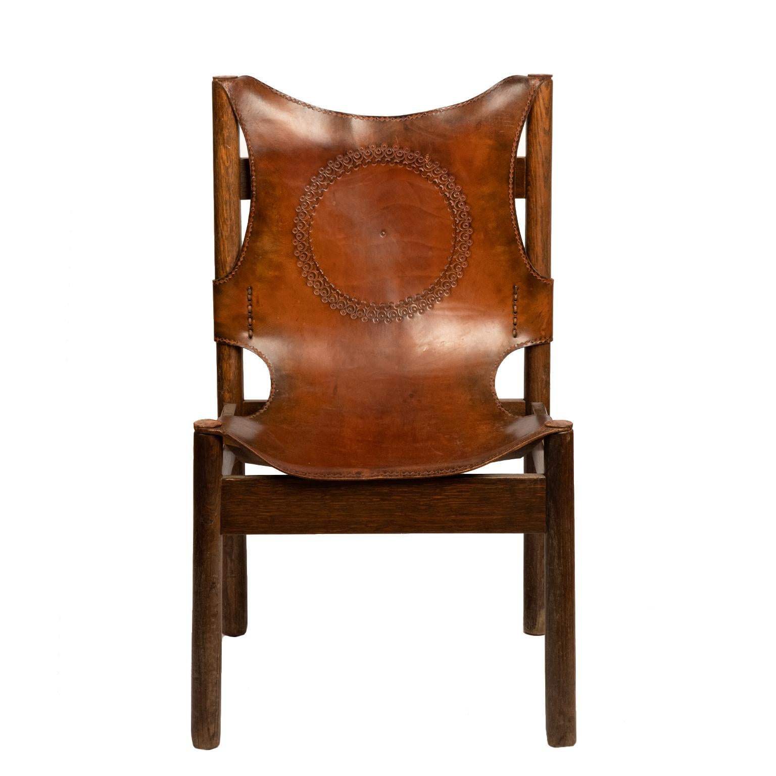 This gorgeous pair of deep cognac brown leather Spanish chairs are rustic yet stylish.
A thick patinated leather with a centre embossed medallion is stitched around a solid dark hardwood frame. They are both stable and can be used at your leisure.