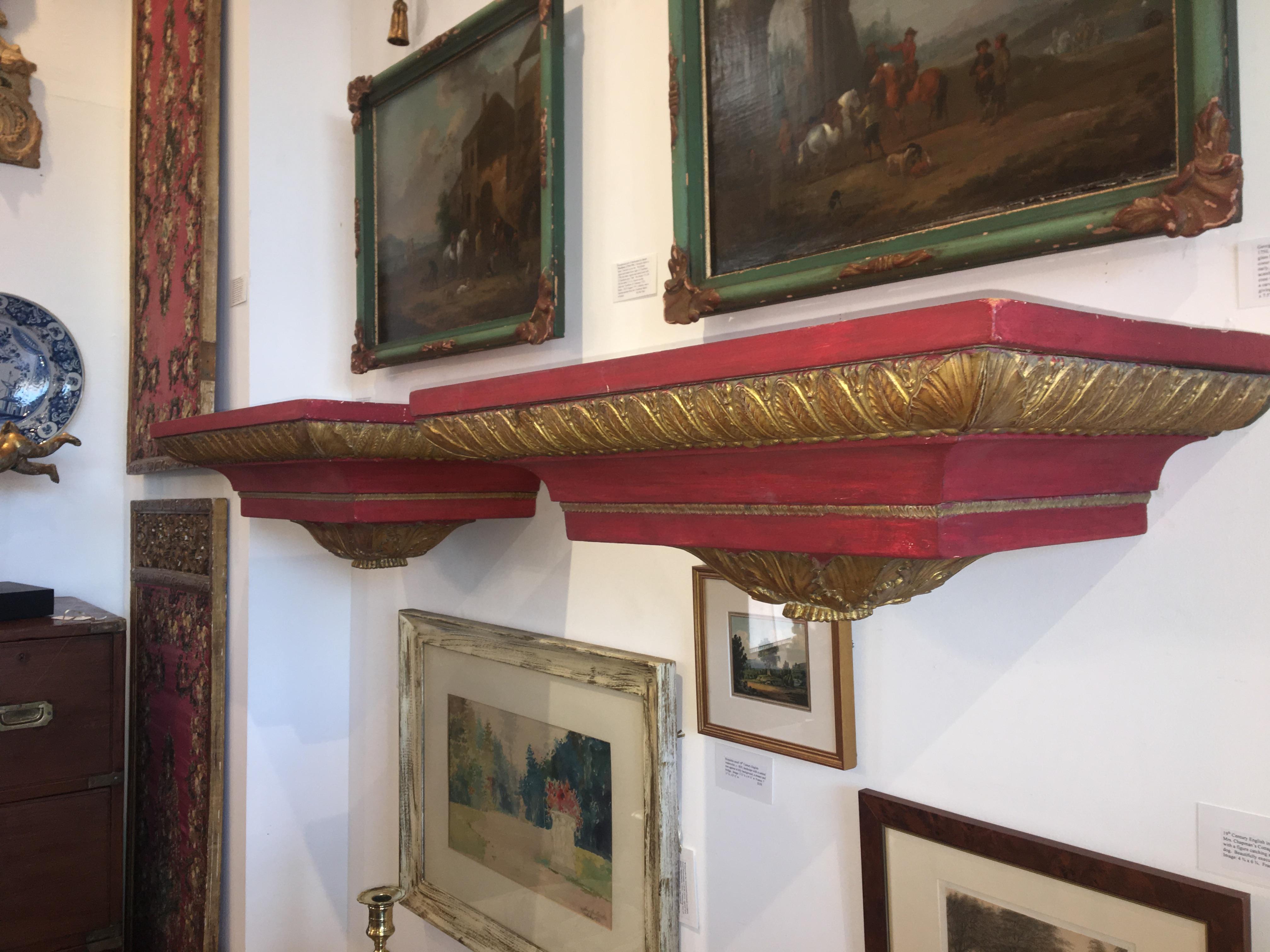 A pair of European, possibly Swedish, architectural red and parcel-gilt wall shelves, early 20th Century constructed using beautifully carved 18th century moldings.