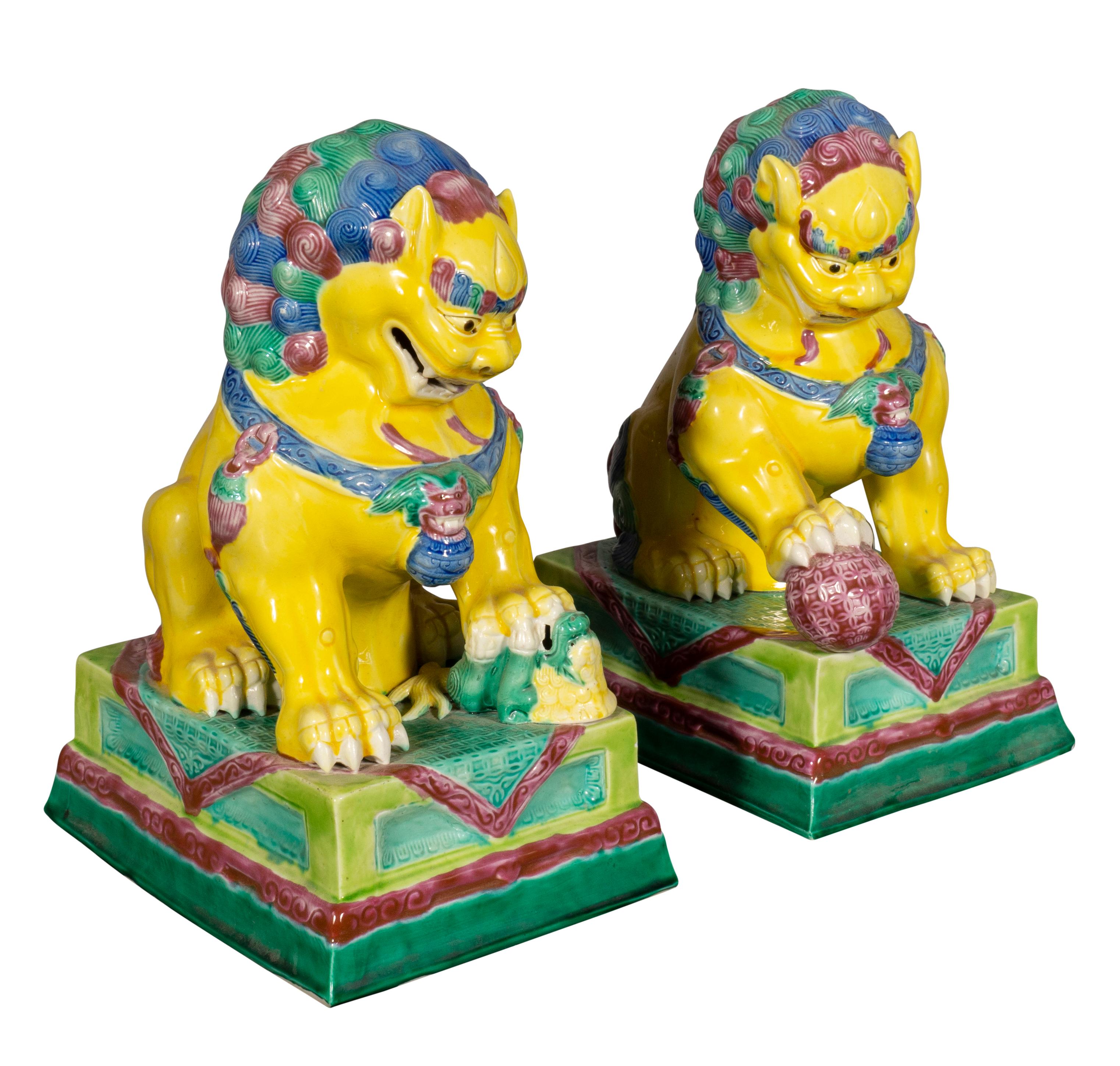 Brightly painted with a male and female foo dog or Buddhistic lion one holding a ball for the material world and the female with the cub representing the spiritual.