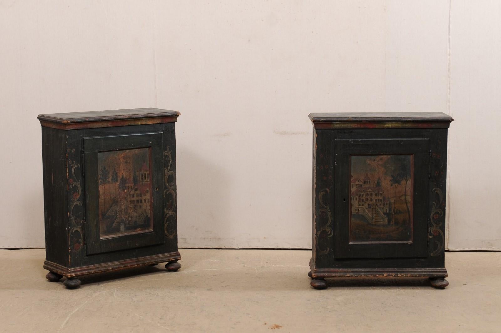 A pair of Central European single-door cabinets with their original artistic hand painted finish from the 19th century. This antique pair of cabinets from Europe each feature a rectangular-shaped top over a case fitted with a single door at front,