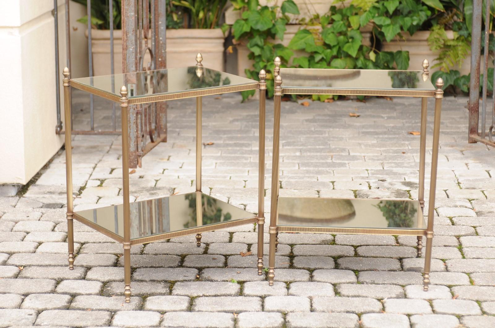 A pair of French or Italian bronze end tables from the mid-20th century, with new distressed mirrored tops and shelves. Each of this pair of end tables features an elegant bronze structure supporting a custom-made distressed mirrored top and lower