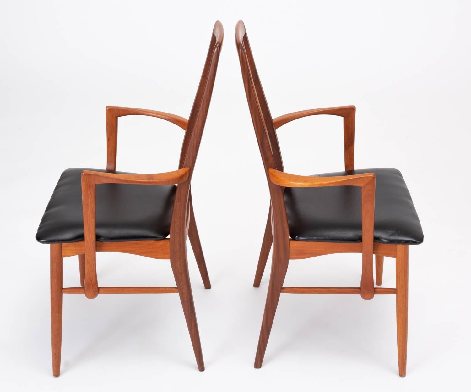 A pair of “Eva” Captain armchairs by Niels Koefoed for his family company, Koefoeds Mobelfabrik of Hornslet, Denmark. Designed in 1964, the Eva chair is defined by its sloped backrest and three vertical slats that conform to the curves of the frame.