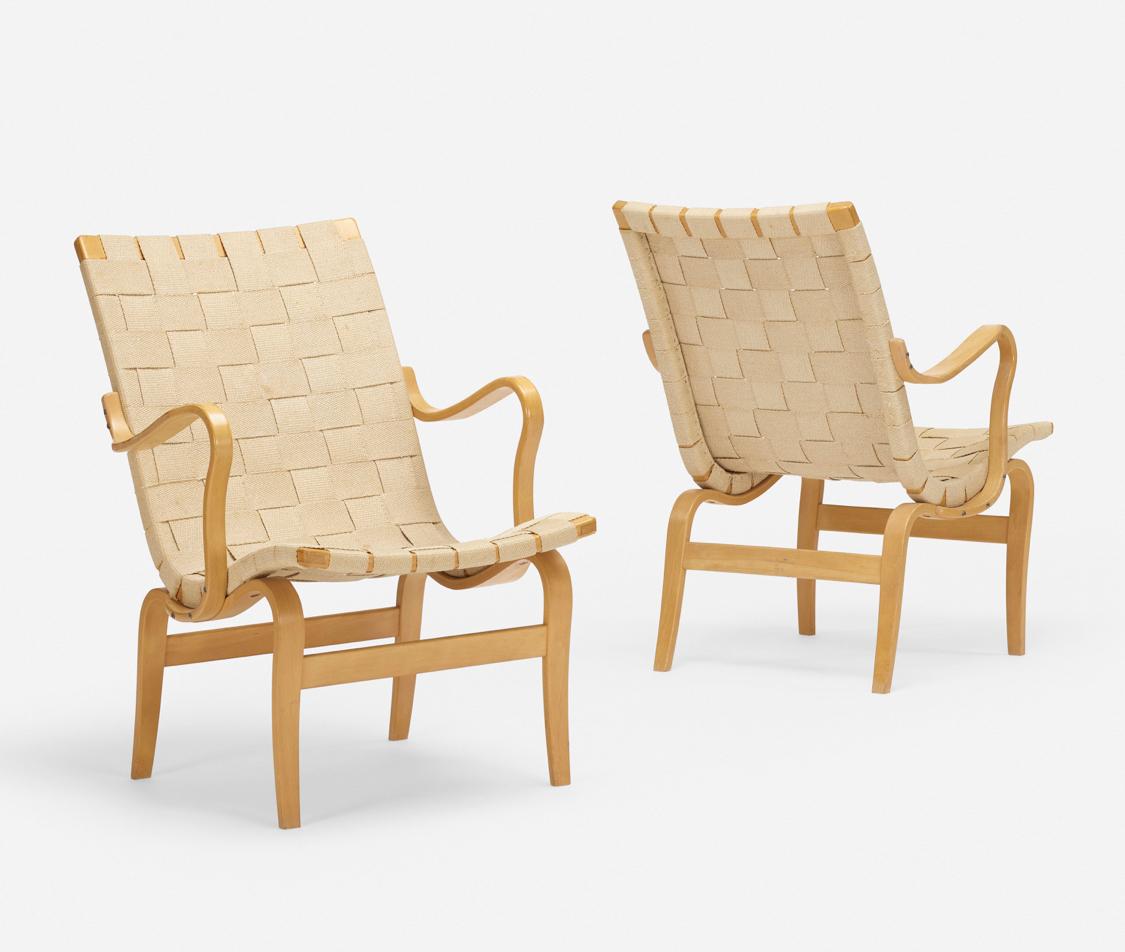 Beautiful pair of Eva chairs by Bruno Mathsson, Sweden, 1970s. Laminated and steam-bent beech, canvas webbing, in great condition. Branded manufacturer's mark to base of each chair.