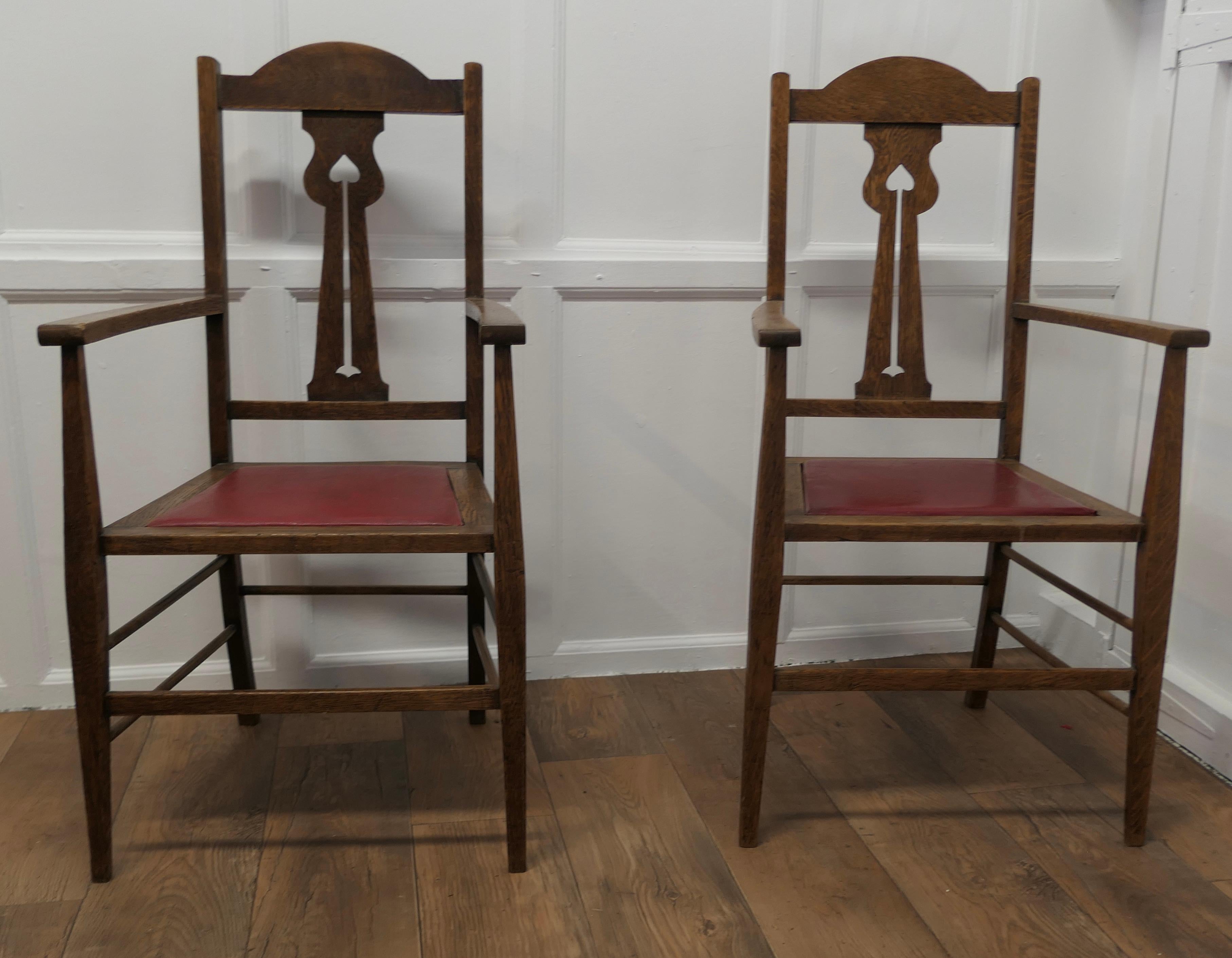 Pair of Excellent Quality Arts and Crafts Oak Carver Chairs

A good pair of chairs very stout and sturdy, in the Arts and Crafts style with an interesting geometric pierced back splat, the Oak has a lovely patina and the upholstery is good 
The