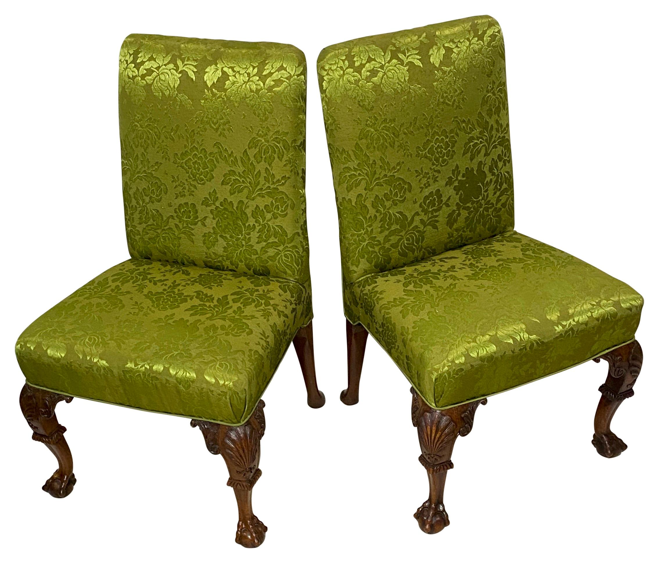 A pair of mahogany claw and ball Chippendale period side chairs. These chairs have broad generous seats, recently re-upholstered. Very strong, solid, and extremely comfortable.
In superb condition. 
England 18th century.