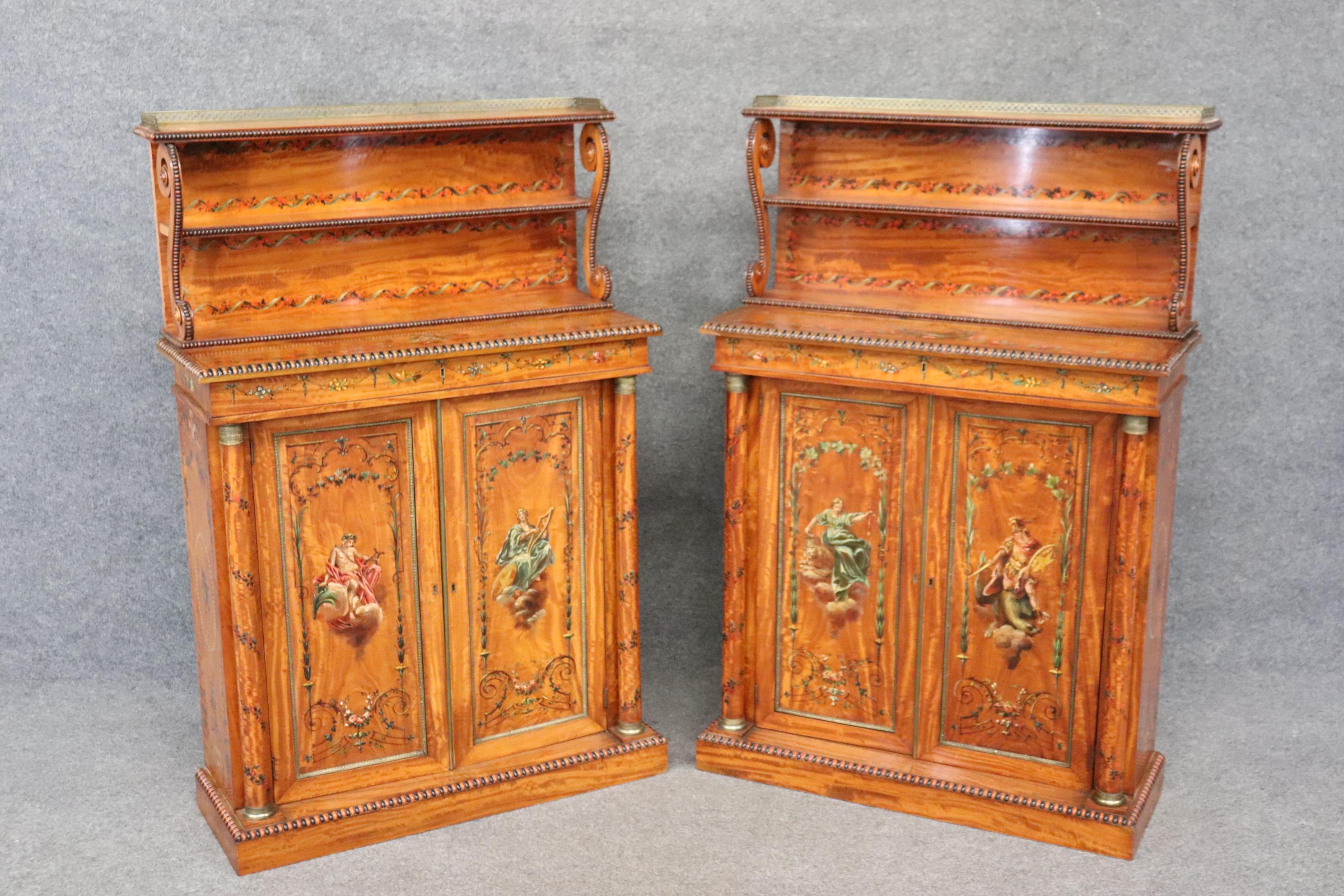 This is an exceptional and truly rare pair of paint decorated solid satinwood side cabinets. They date to the 1890s era and are in good conditon for their age and have no issues beyond normal minor signs of age and use. They measure 51.5 tall x 34