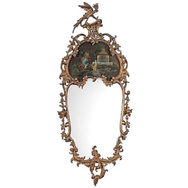 A pair of carved giltwood mirrors, each having connected cartouches, with framed of s-and c-scrolls, waves, and rocaille, surmounted by a carved and gilt phoenix, the top cartouche decorated with polychrome Chinese garden scene.

The Victorians