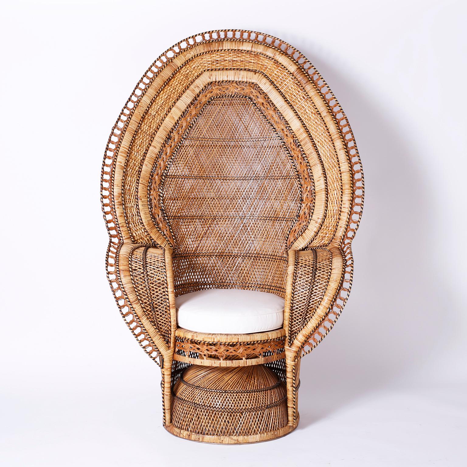 Transporting pair of peacock chairs from the Philippines crafted with rattan and reed in a complex pattern of materials and designs with an unusual exotic form. Best of the genre.

From left to right:

H: 66 W: 45 D: 32 Seat height: 22 with