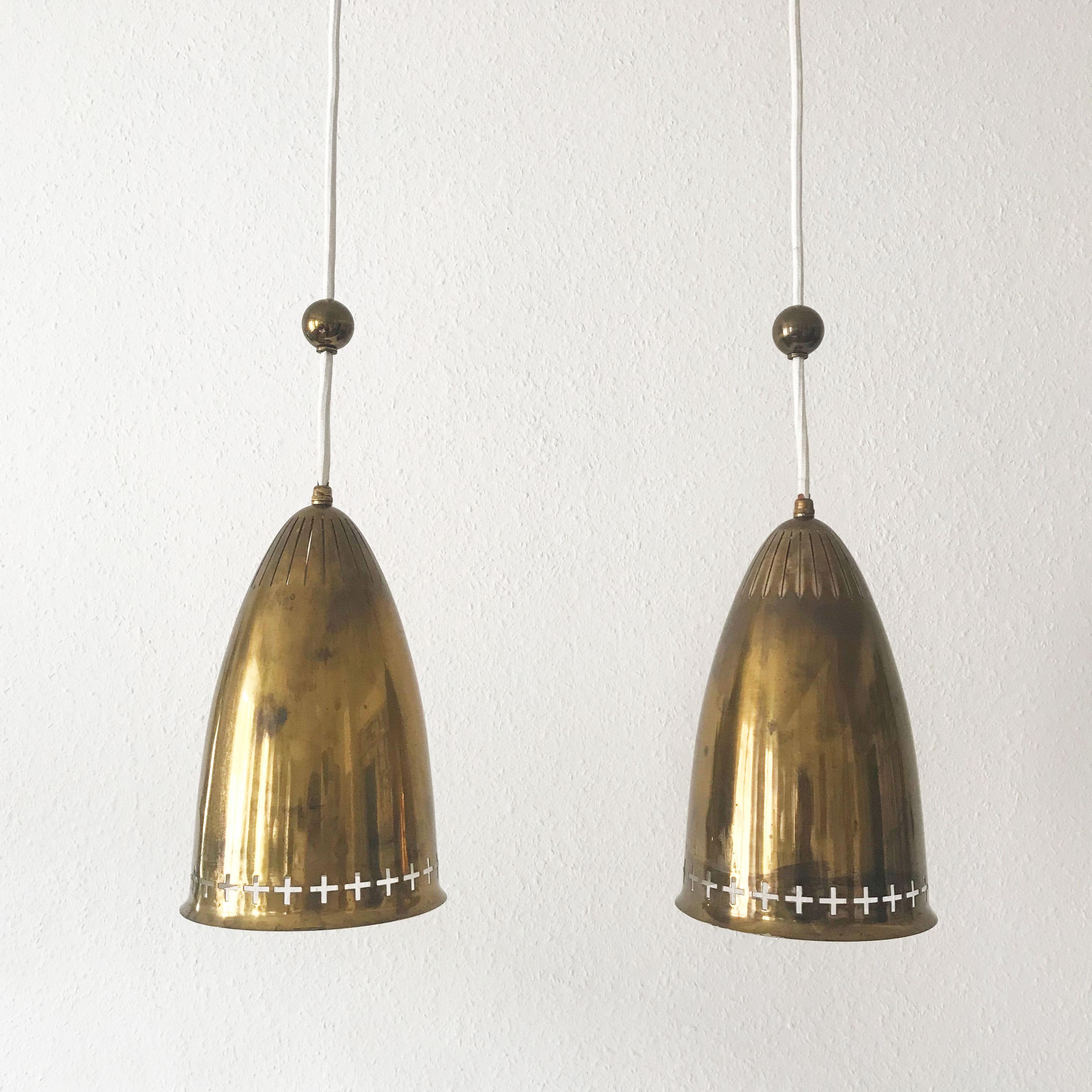 Pair of extremely rare and lovely Mid-Century Modern pendant lamps with perforated lampshades in brass. Designed and manufactured probably in Finland or Sweden in 1950s.

Each lamp is executed with an E27 screw fit bulb holder, re-wired and in