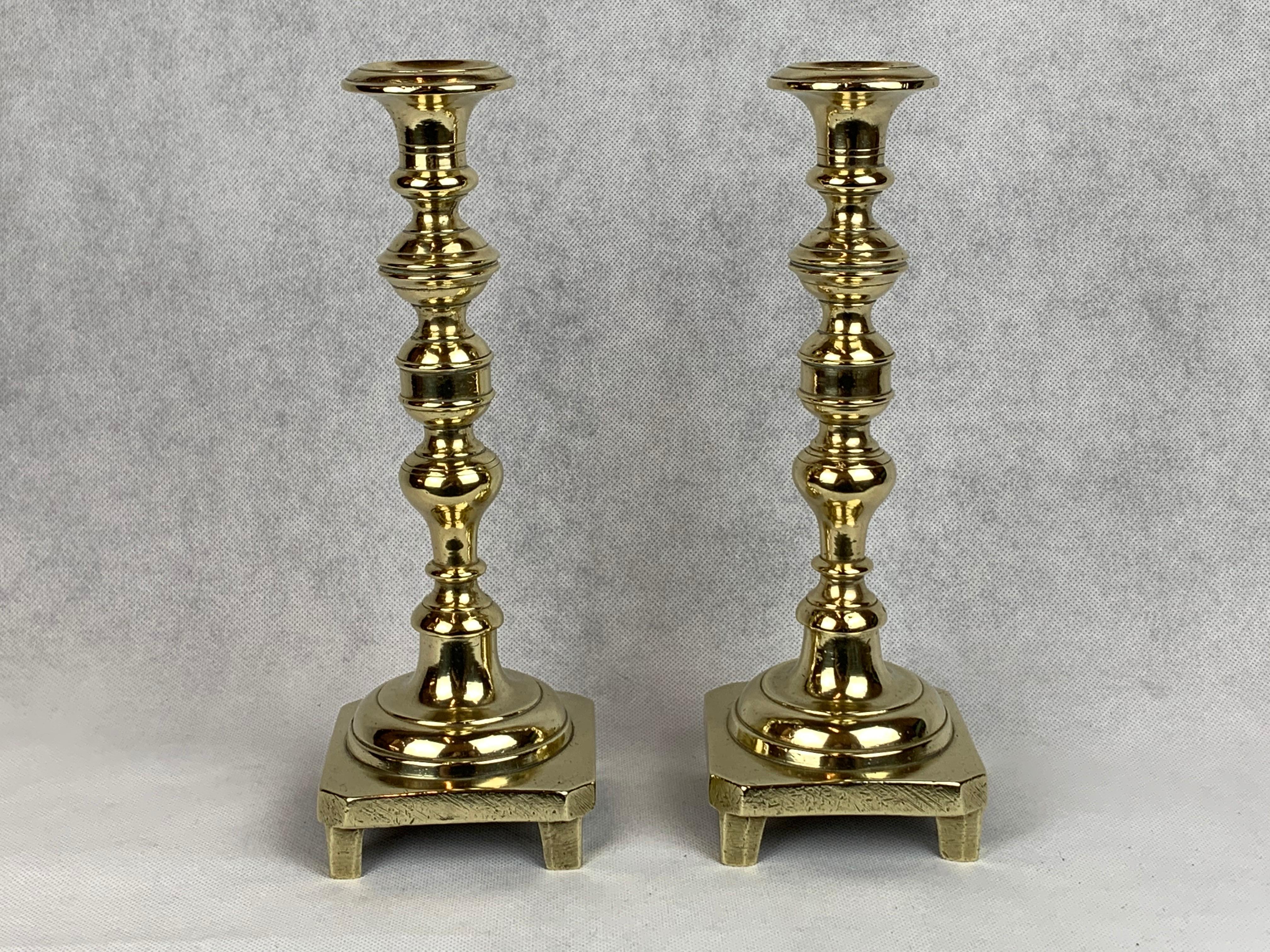 Russian A Pair of Solid Brass Footed Candlesticks with Square Bases, Russia, 19th c. For Sale