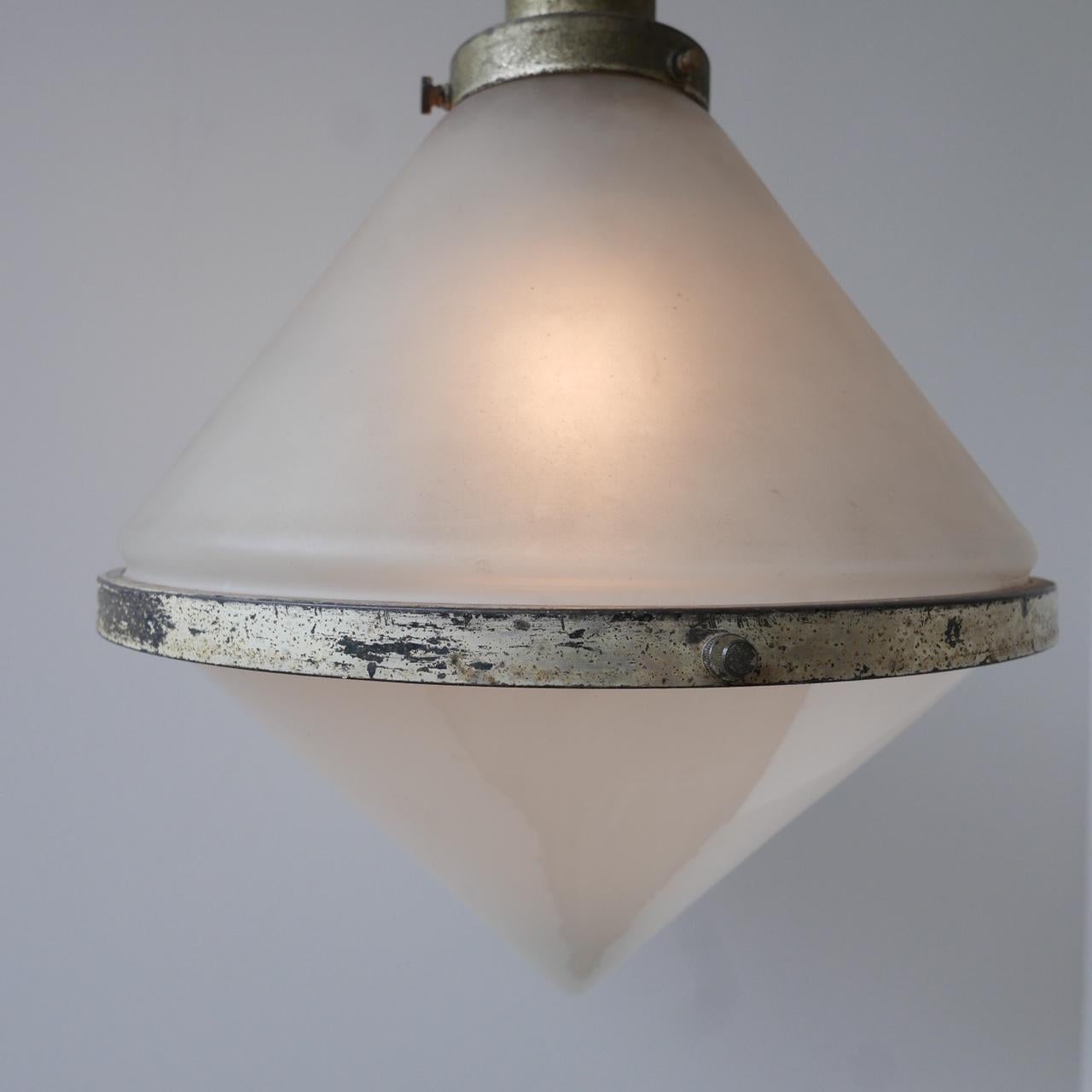 The largest and rarest pair of Peter Behrens pendant lights available on the market. 

We have never seen this model before. 

Two tone glass, with original Siemens & Schuckert logo to the glass. 

Early 20th century, Germany. 

Patina to