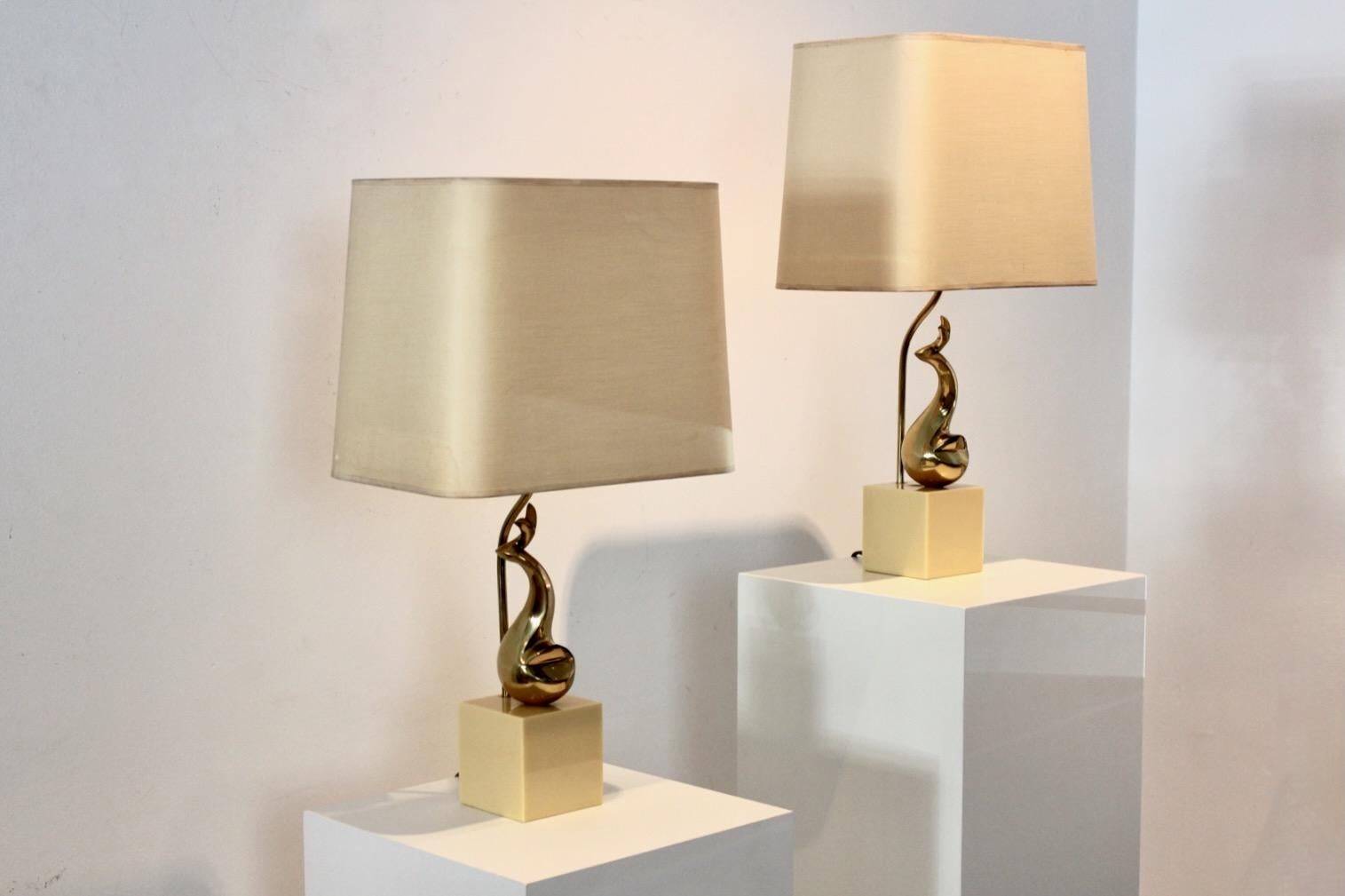 Rare pair of Table lamps by French Artist Philippe-Jean, France, 1970s. These sophisticated midcentury Table Lamps have a fine gilded brass sculpture on a creamy-marble foot with the original shades. Normal wear on the shades due to age and use. The