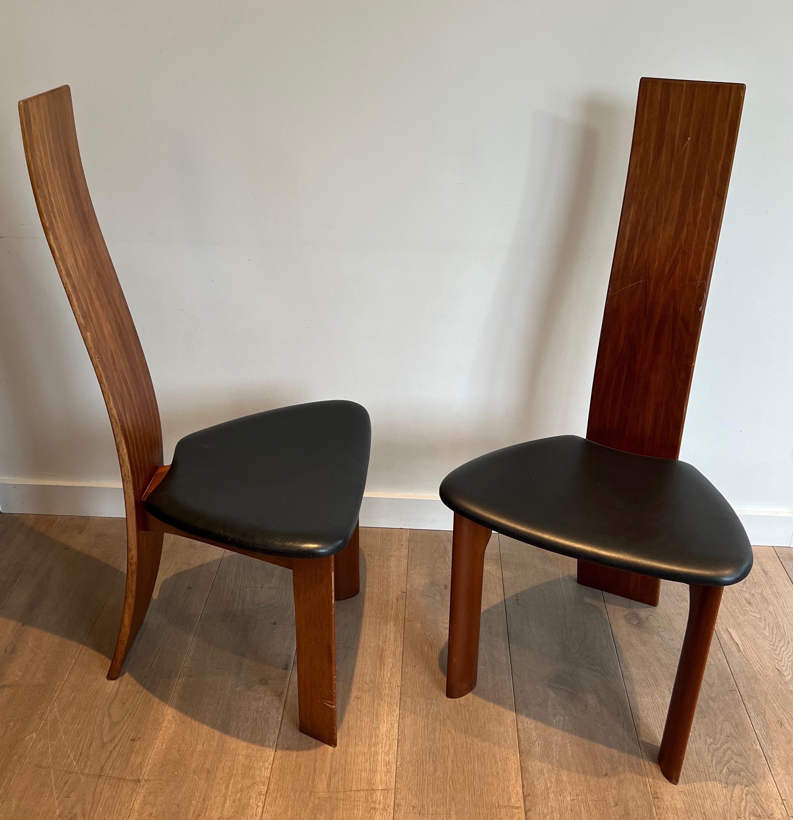 This pair of chairs is made of exotic wood with black leather seats, This is a French Work. Circa 1970