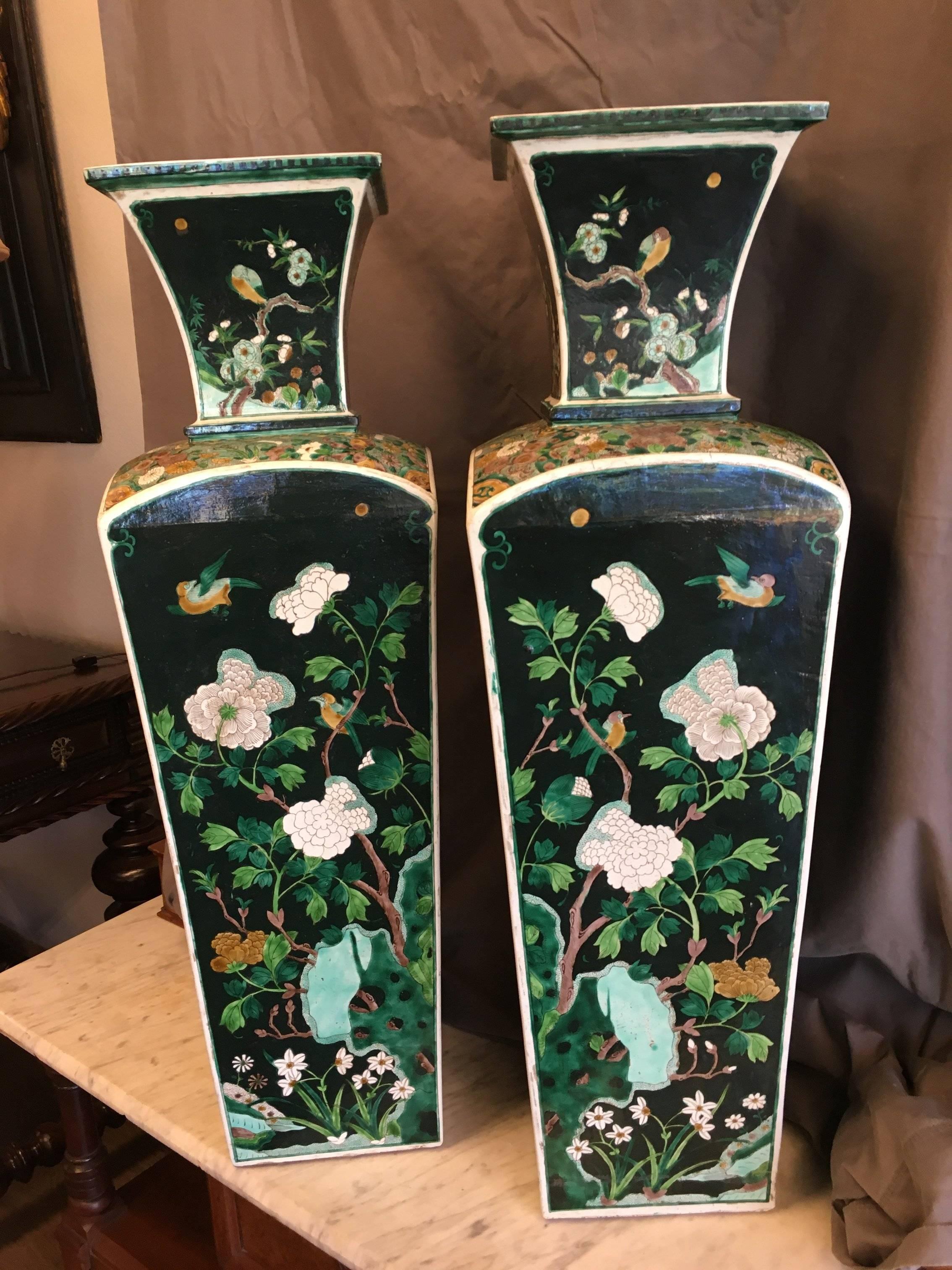 Striking pair of large mirror-imaged Chinese Qing (a.k.a. Manchu) dynasty porcelain square section vases enameled in the famille-noir style, circa 1840. Each impressive vase is fashioned with tapering sides on the neck and body divided into four