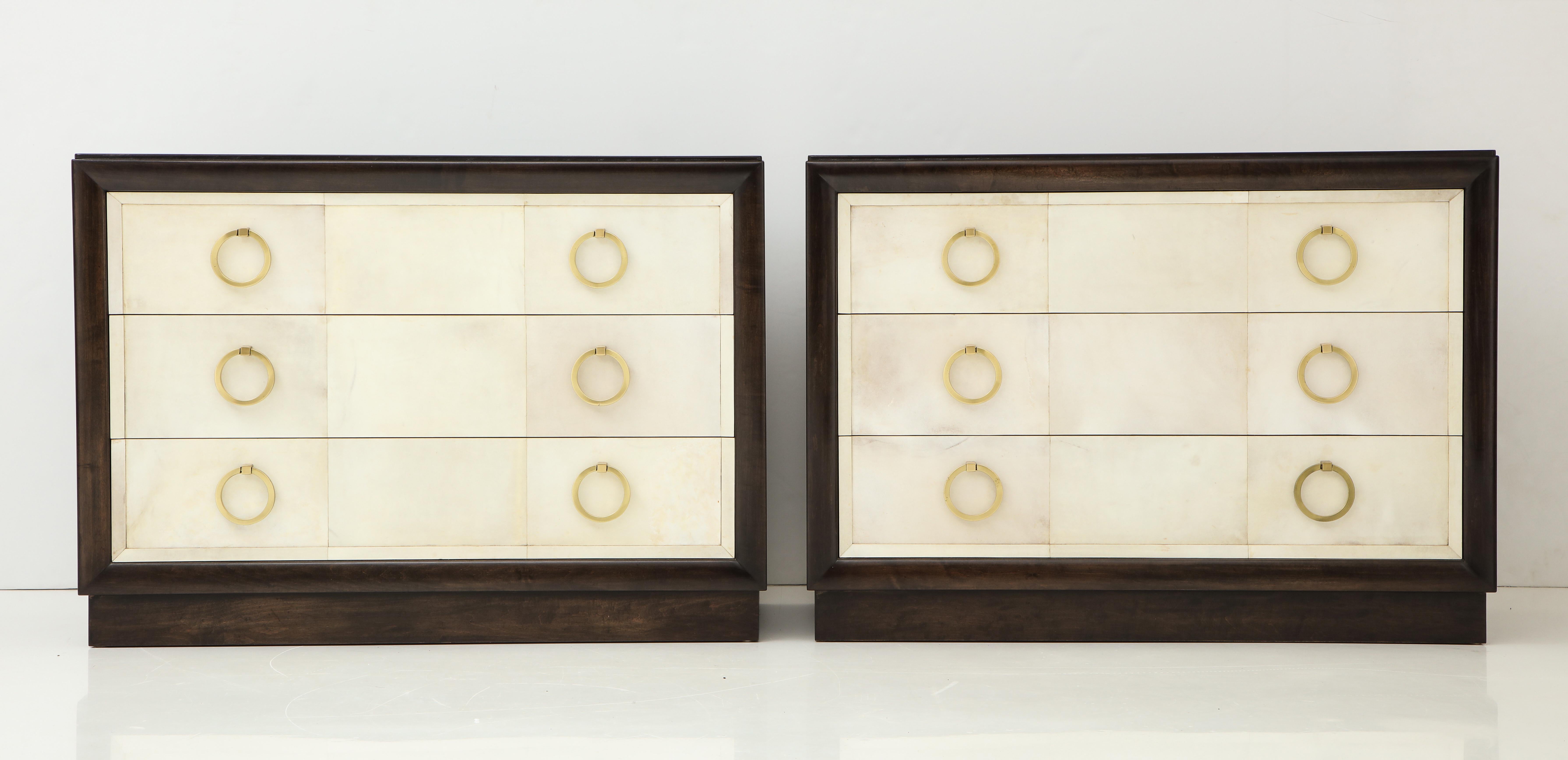 Pair of exquisite 1950s lacquered parchment dressers by T H Robsjohn Gibbings.
The rich brown Mahogany cabinets have been beautifully restored and are complemented by lacquered parchment drawer fronts and satin brass ring pulls.
 