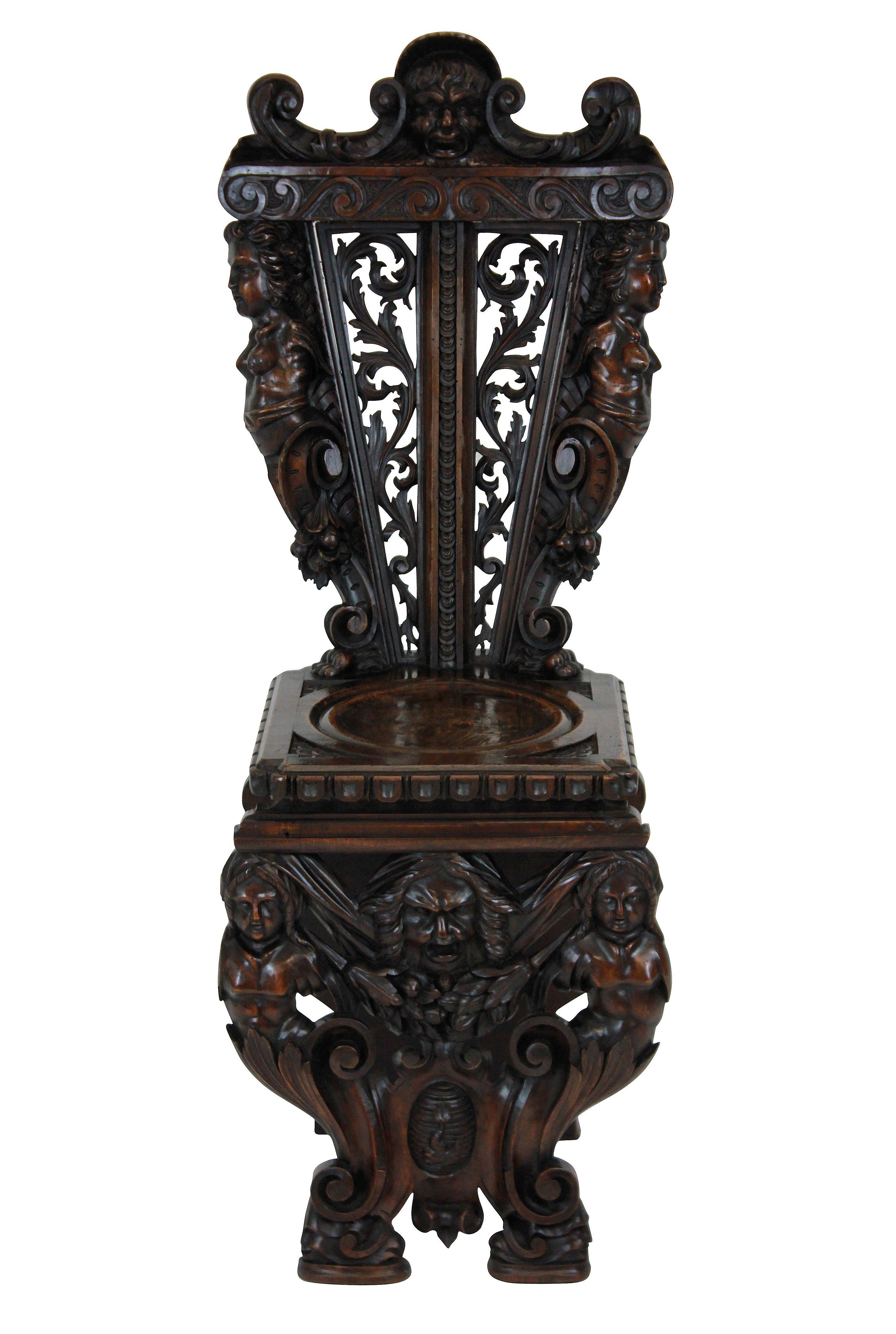 A pair of fine early 19th century Italian exquisitely carved walnut hall chairs in the Renaissance revival manner. Profusely decorated with foliage, caryatids and a coat of arms.

 