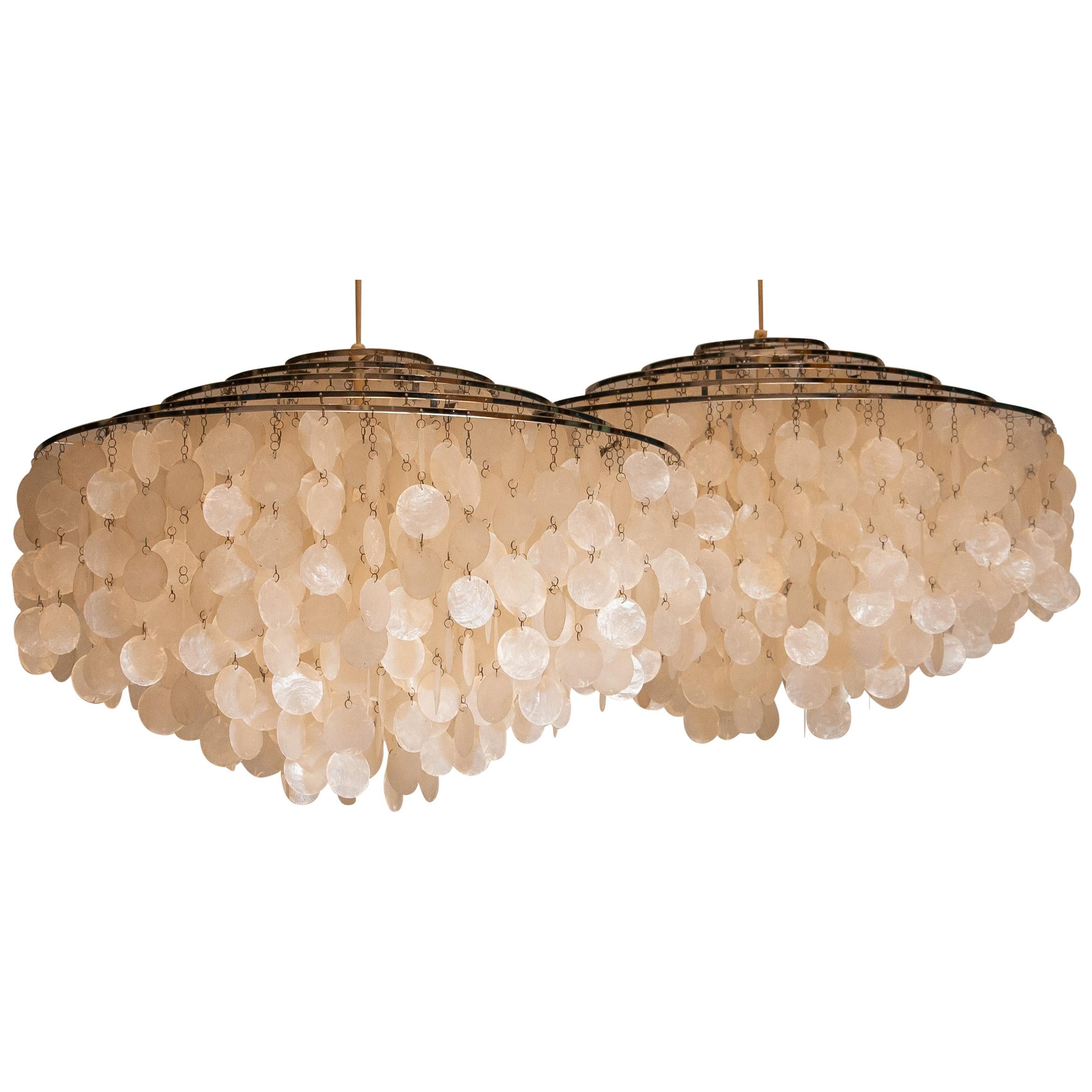 Beautiful set of two complete original extra large capiz shell chandeliers designed by Verner Panton for J. Luber Ag in Switzerland, 1964.
These two extra large chandeliers measures a diameter of 70cm. or 27.56