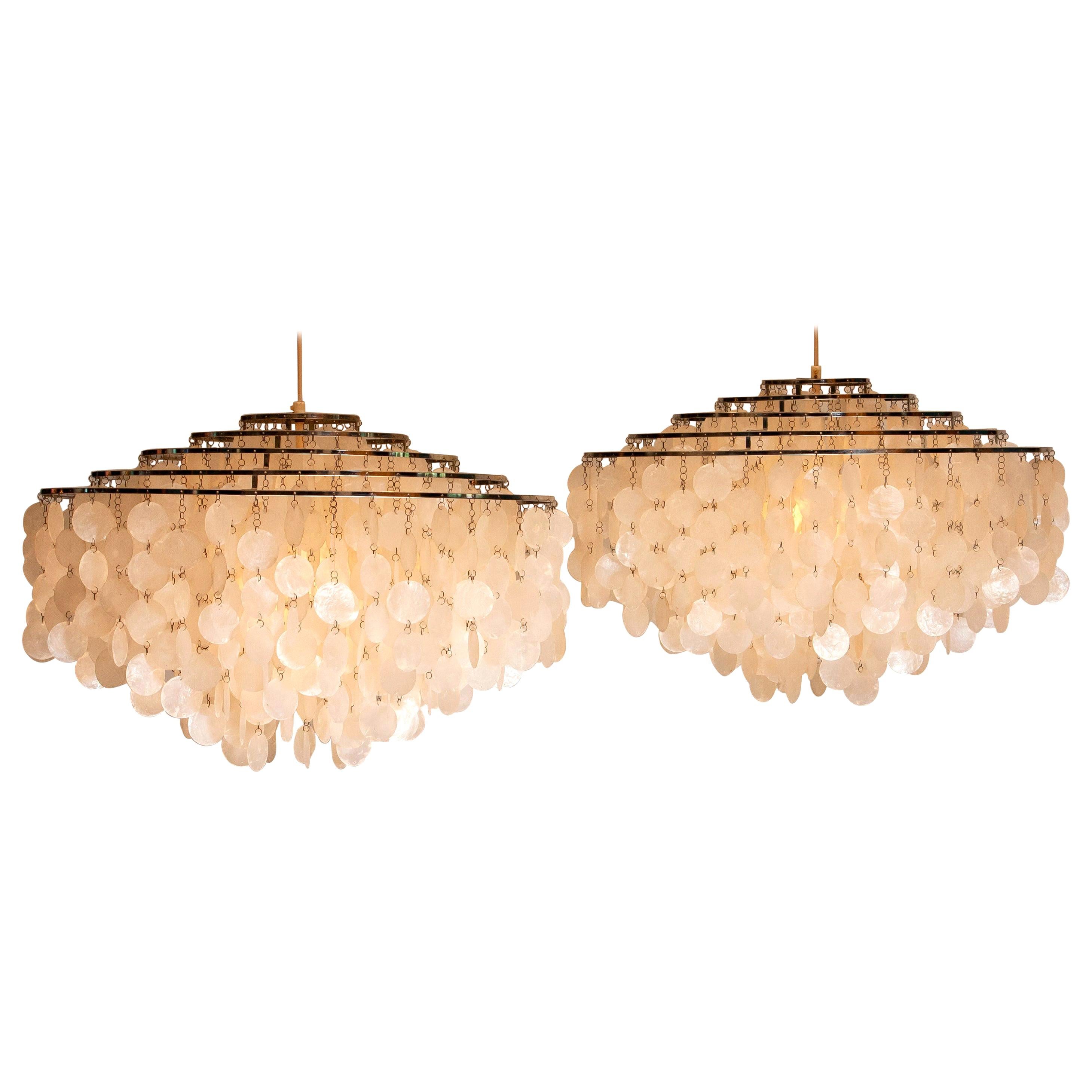 Beautiful set of two complete original extra large capiz shell chandeliers designed by Verner Panton for J. Luber Ag in Switzerland, 1964.
These two extra large chandeliers measures a diameter of 70cm. or 27.56