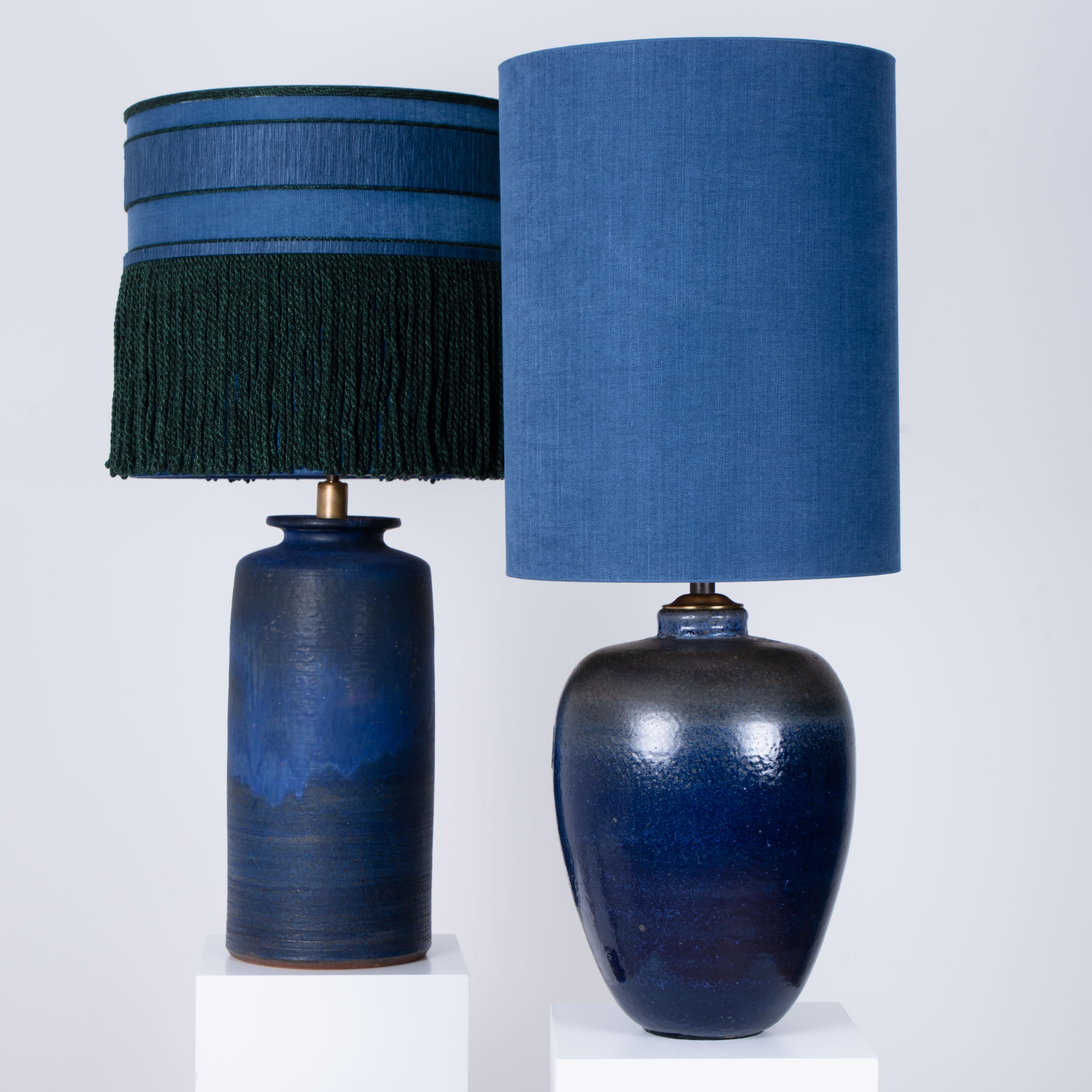 An exceptional pair of high-end ceramic table lamps, Denmark, 1960s. Sculptural pieces, made of handmade ceramic in blue tones. With a combination of glazed and with new custom made silk lamp shades by René Houben. With warm bronze or gold inner,
