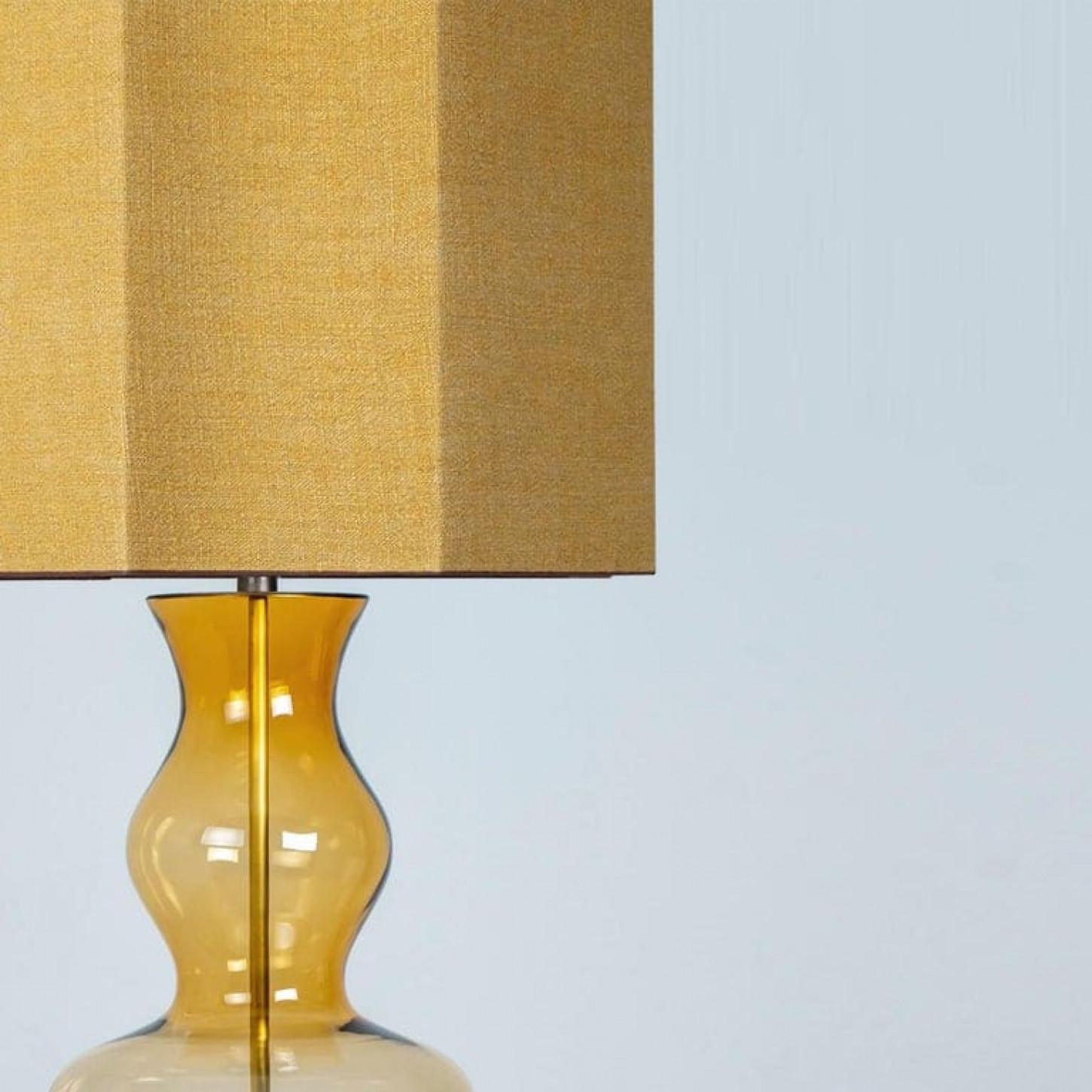 A unique Minimalist timeless design. Each extra large glass table lamp features a green exceptional transparent shaped base with a solid walnut wooden foot with old brass accents and a brass rod running through the center. Enhancing the light and