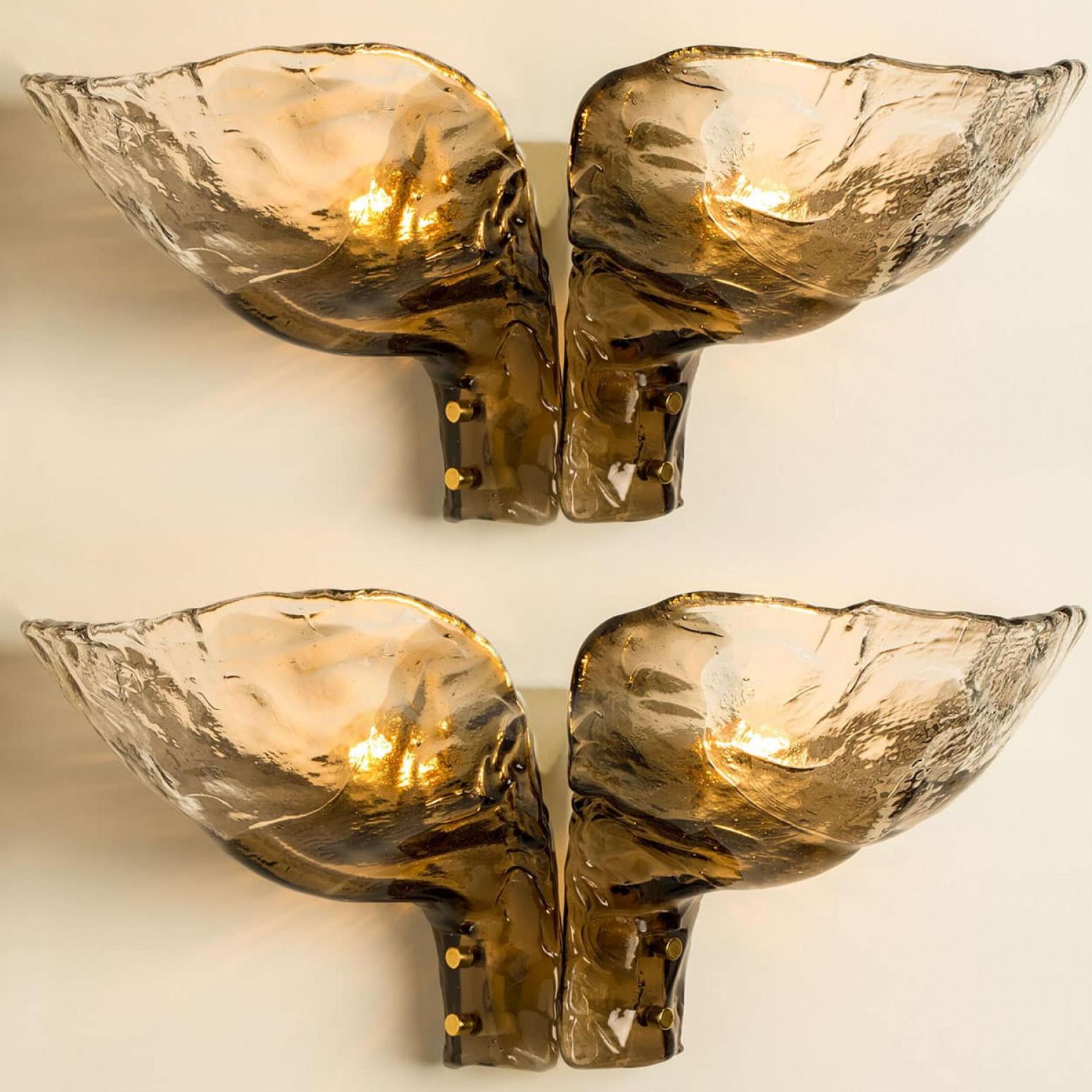 XL Smoked glass wall lamps from the 1960s. Spectaculair  design and  high quality workmanship.
The light illuminates lovely due to the  smoked and structured glass, it creates a spectacular play of light.

In excellent vintage condition , cleaned
