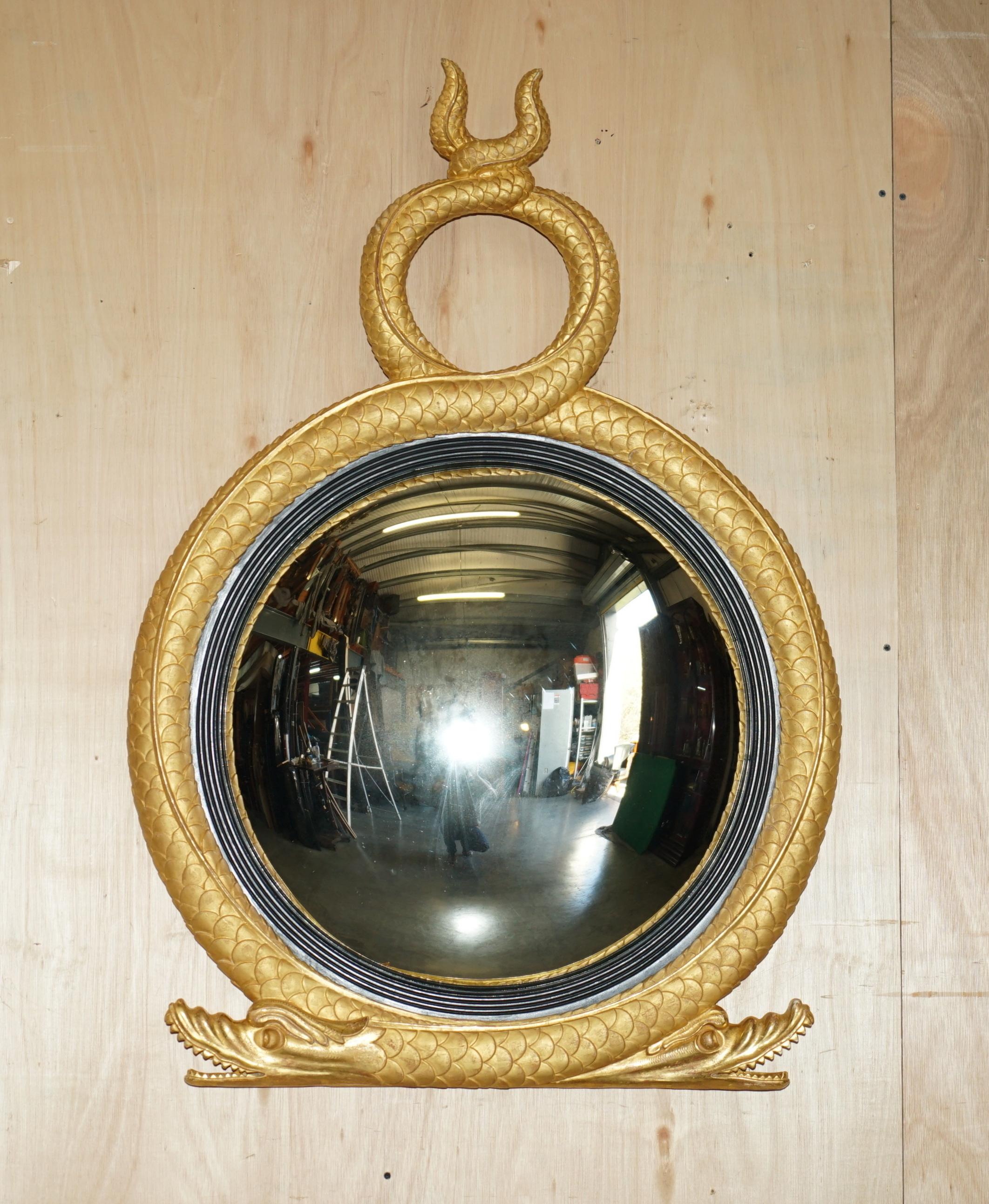 Royal House Antiques

Royal House Antiques is delighted to offer for sale this stunning pair of English Regency style gold gilt extra large Twin Serpent Convex mirrors

Please note the delivery fee listed is just a guide, it covers within the M25