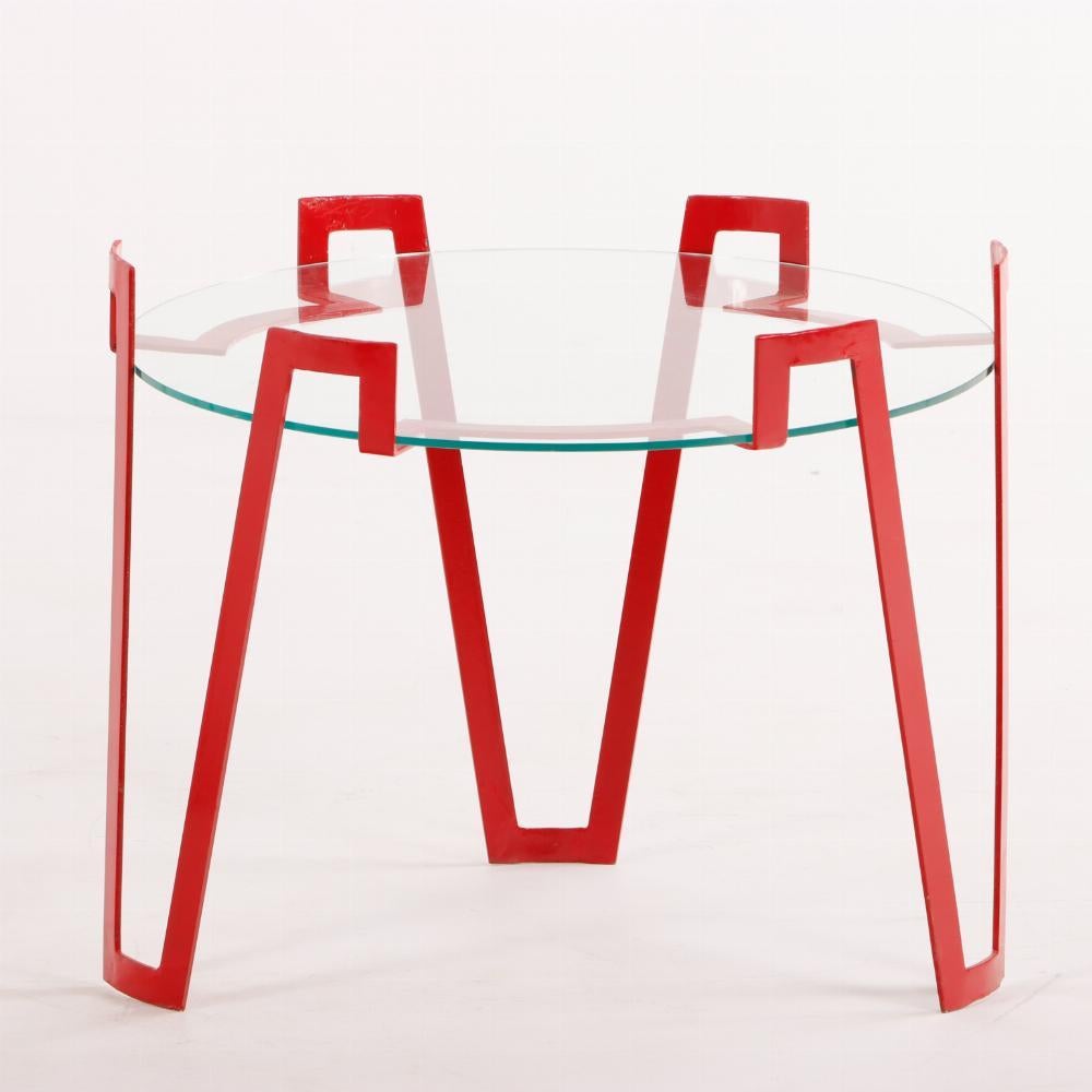A pair of eye-catching red iron and glass end tables.  Each with round glass top supported by geometric tripod iron base painted red. Wonderful end tables to make a statement in your décor.