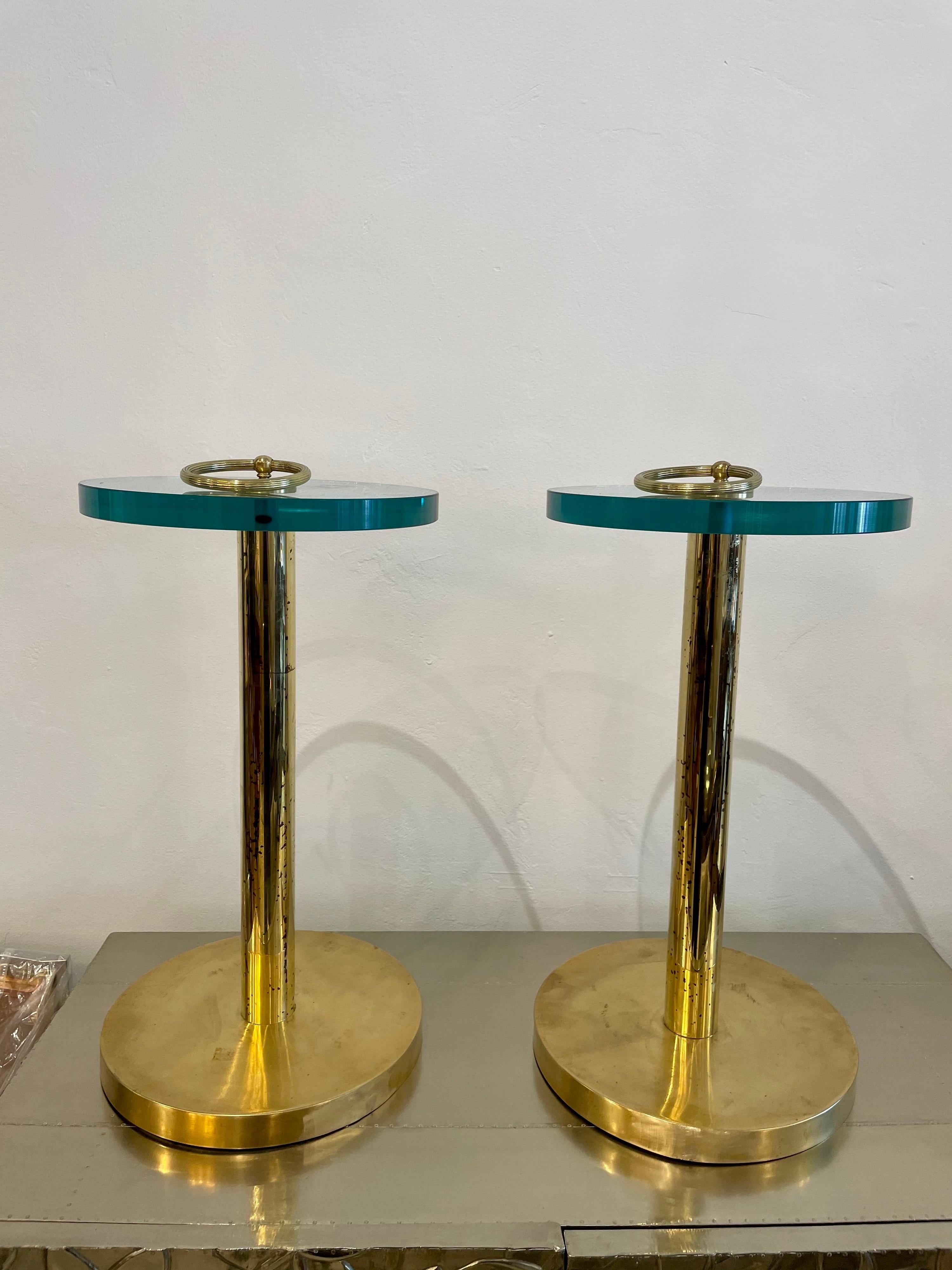 Showing wonderful age and patina, these brass rods and base with accent ring to top are perfect side tables for any decor. Very thick glass tops.