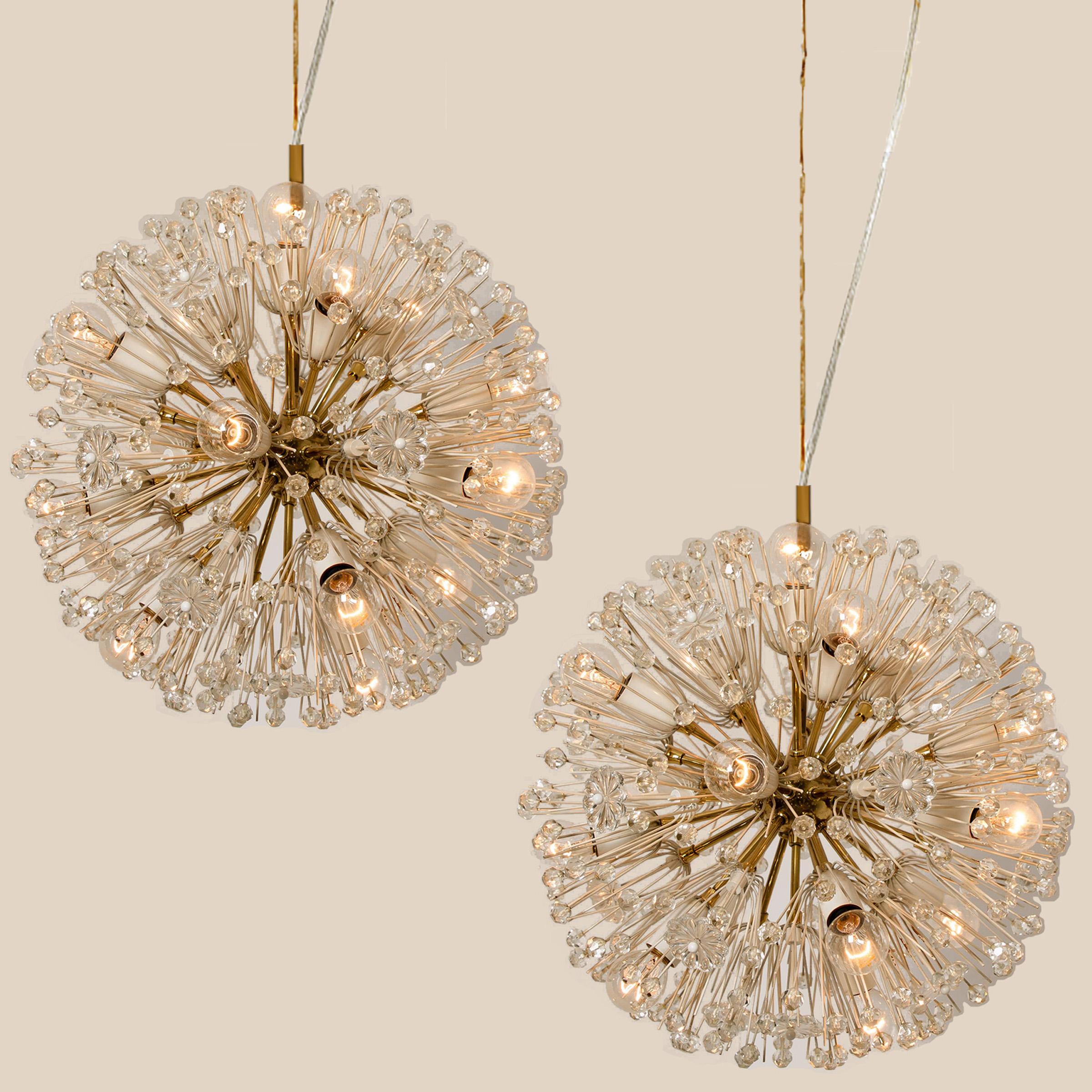 A magnificent pair of light brass Sputnik fixtures with copious amounts of Austrian crystals by Emil Stejnar for Nikoll. Cosmological.
This glamorous delicate brass ‘Snowball’ Sputnik light fixtures are also known as ‘pusteblume’ or ‘snowflake’ and