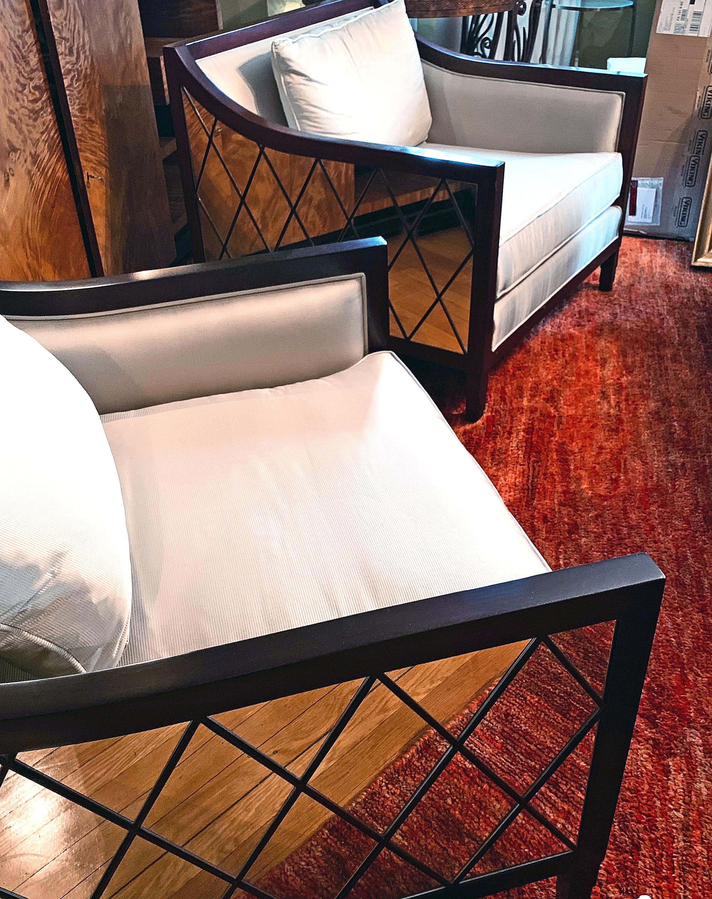 This pair of high-style, gorgeous chairs -- designed and made by Christopher Guy but no longer in production -- feature mirrored sides and backs finished with a stained wood overlay in a diamond pattern, strongly influenced by midcentury Furniture