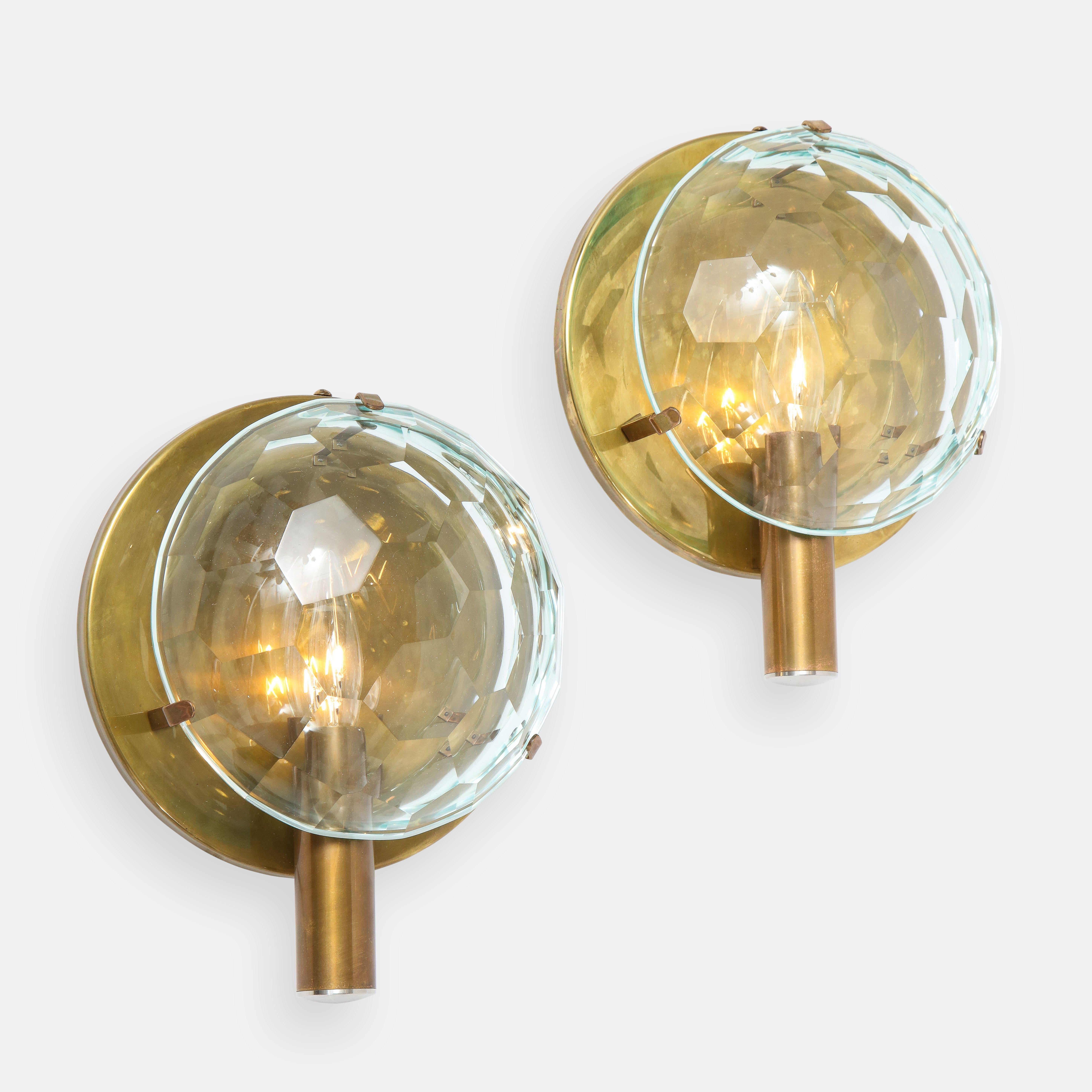 Rare pair of sconces with convex faceted crystal disc suspended by three brass brackets attached to brass circular back plate with tubular socket holder. These elegant sconces are unique design in the manner of Fontana Arte from Italy from the 1950s